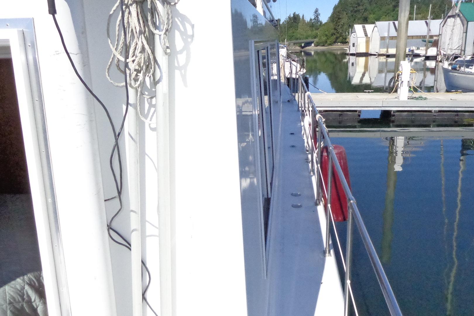 Cruise-A-Home Corsair 4200, 1992 model, docked at a marina with calm waters.