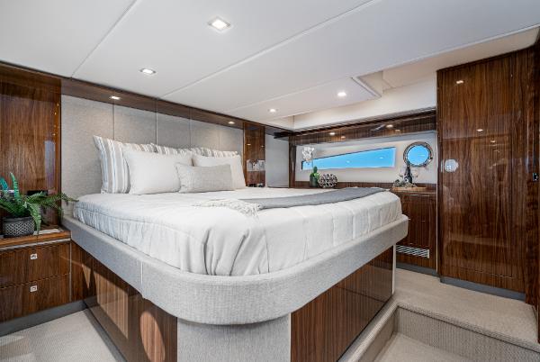 Luxurious bedroom interior of 2021 Riviera 5400 Sport Yacht with modern design and elegant furnishings.