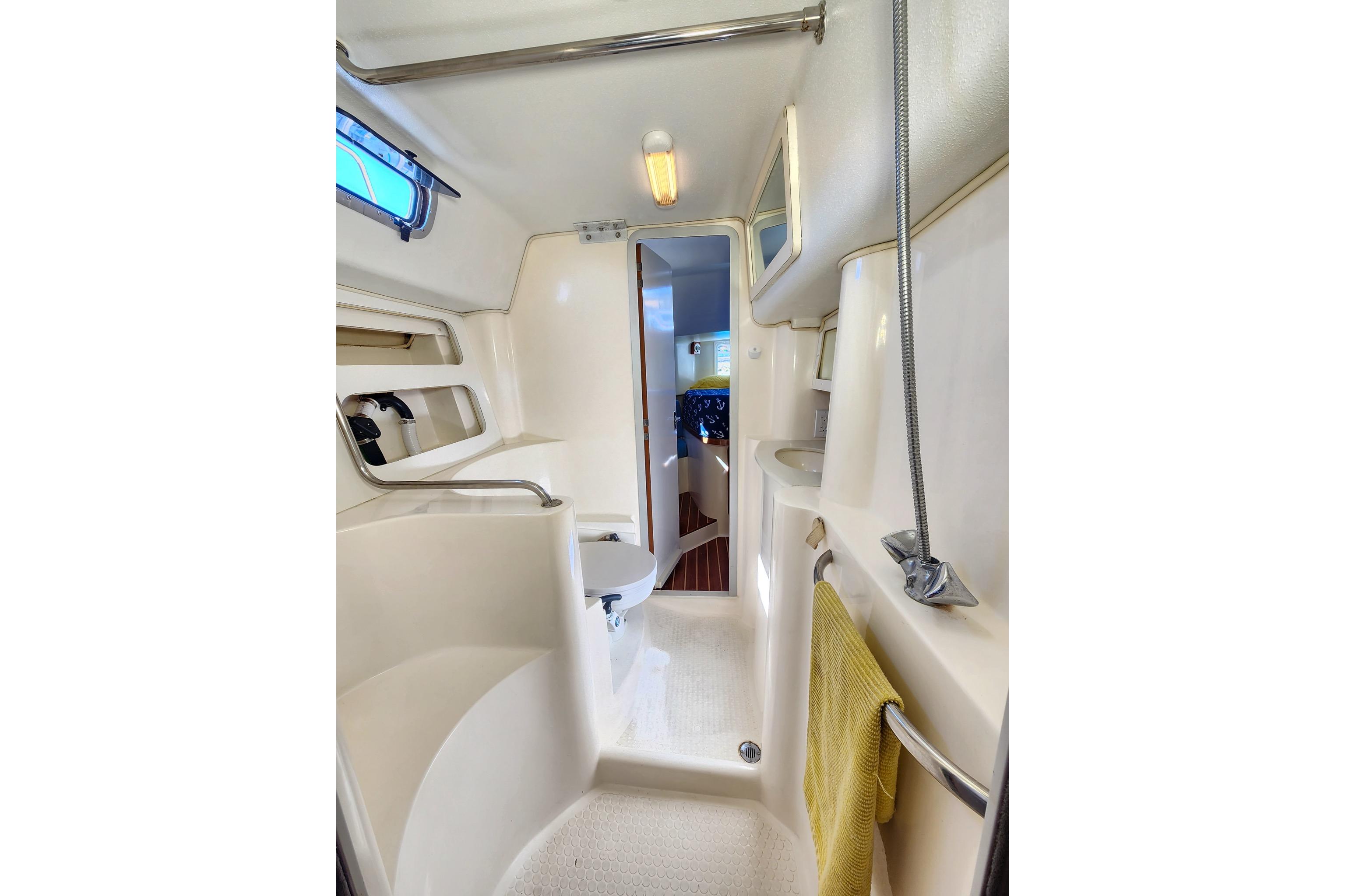 1994 Morgan 38 yacht bathroom interior with shower, sink, and toilet.