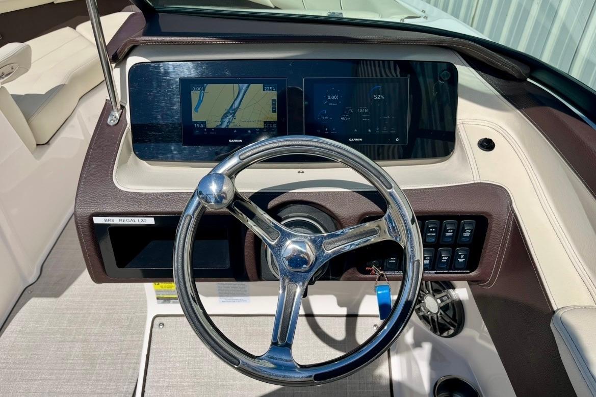 2025 Regal LX2 boat dashboard with steering wheel and digital display.