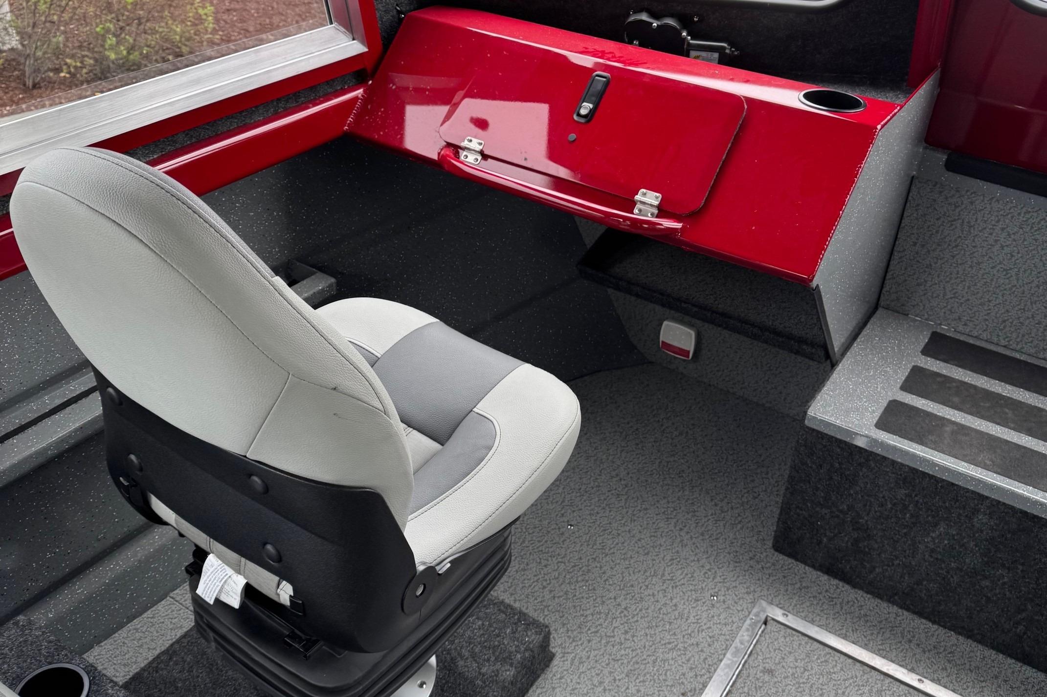 Interior of 2024 Spartan 24 MAXIMUS PRO XL boat with gray seat and red dashboard.