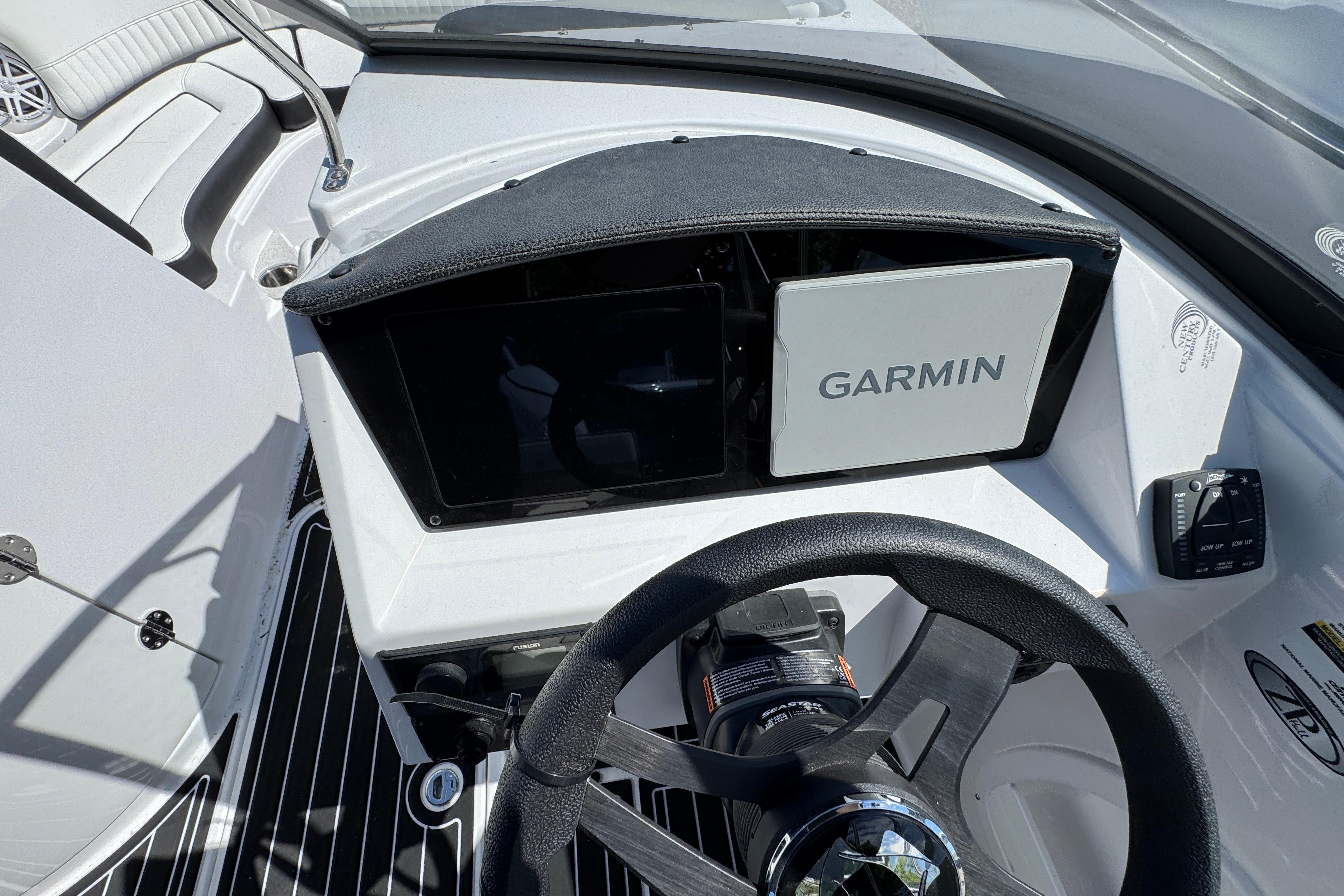 2026 Stingray 231 DC boat dashboard with Garmin navigation system and steering wheel.