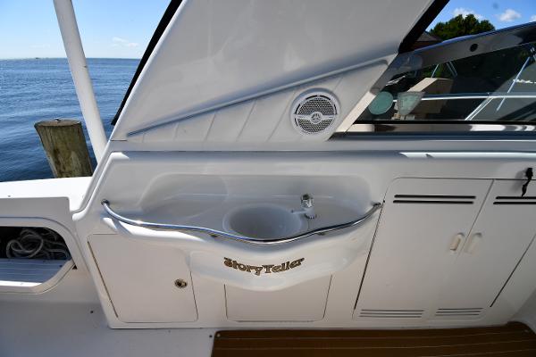 1997 Sea Ray 400 Sundancer yacht interior with sink and storage, docked by the water.