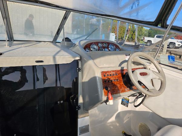 1997 Bayliner 26 Cierra boat cockpit with steering wheel and control panel.