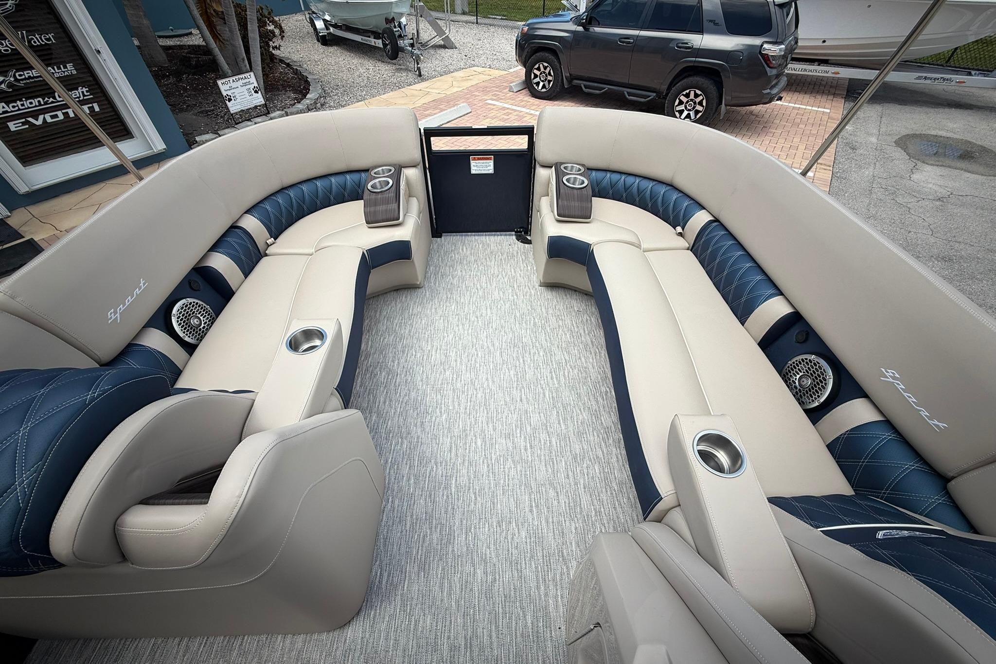 Luxurious interior of 2026 Bennington 27 QSBAT2 pontoon boat with plush seating and cup holders.