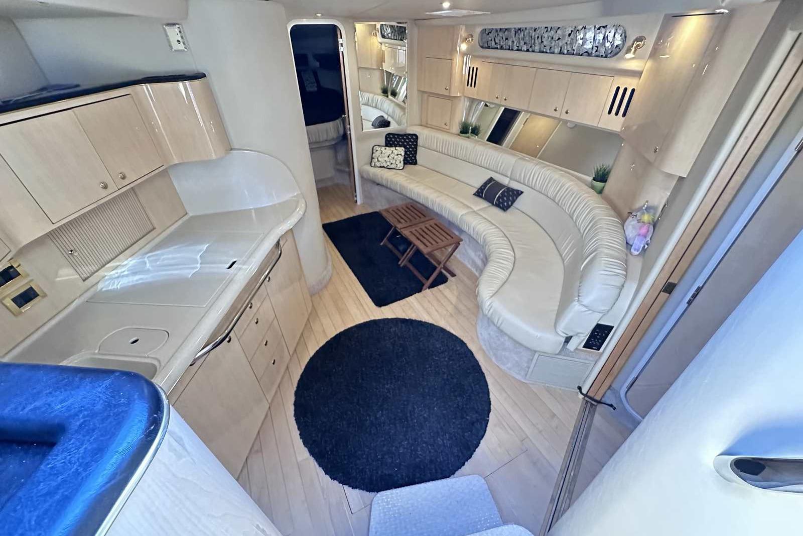 Luxurious interior of 2000 Sea Ray 410 Sundancer yacht with elegant seating and modern amenities.