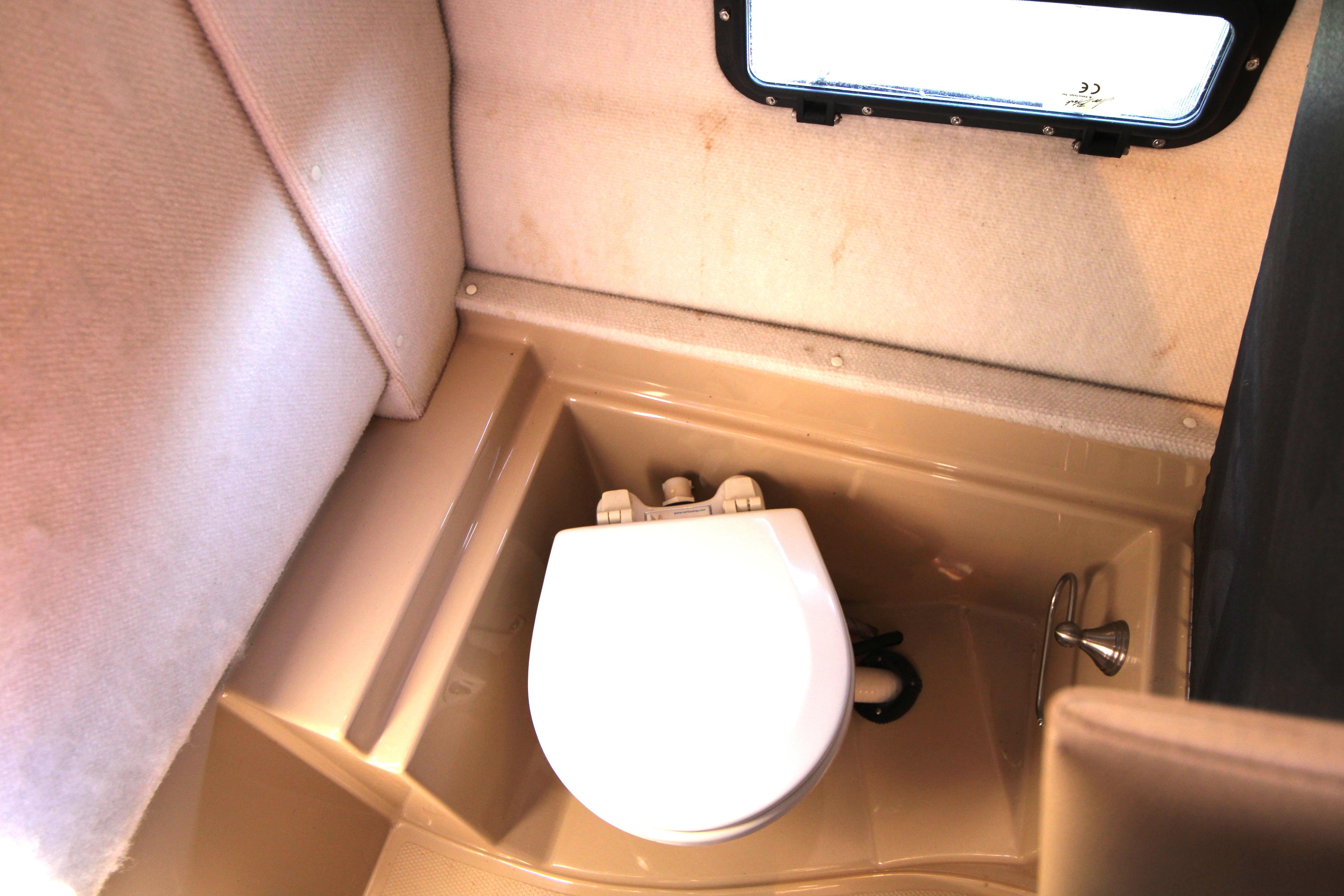 2013 Ranger Tugs R-31 CB boat bathroom with compact toilet and window.