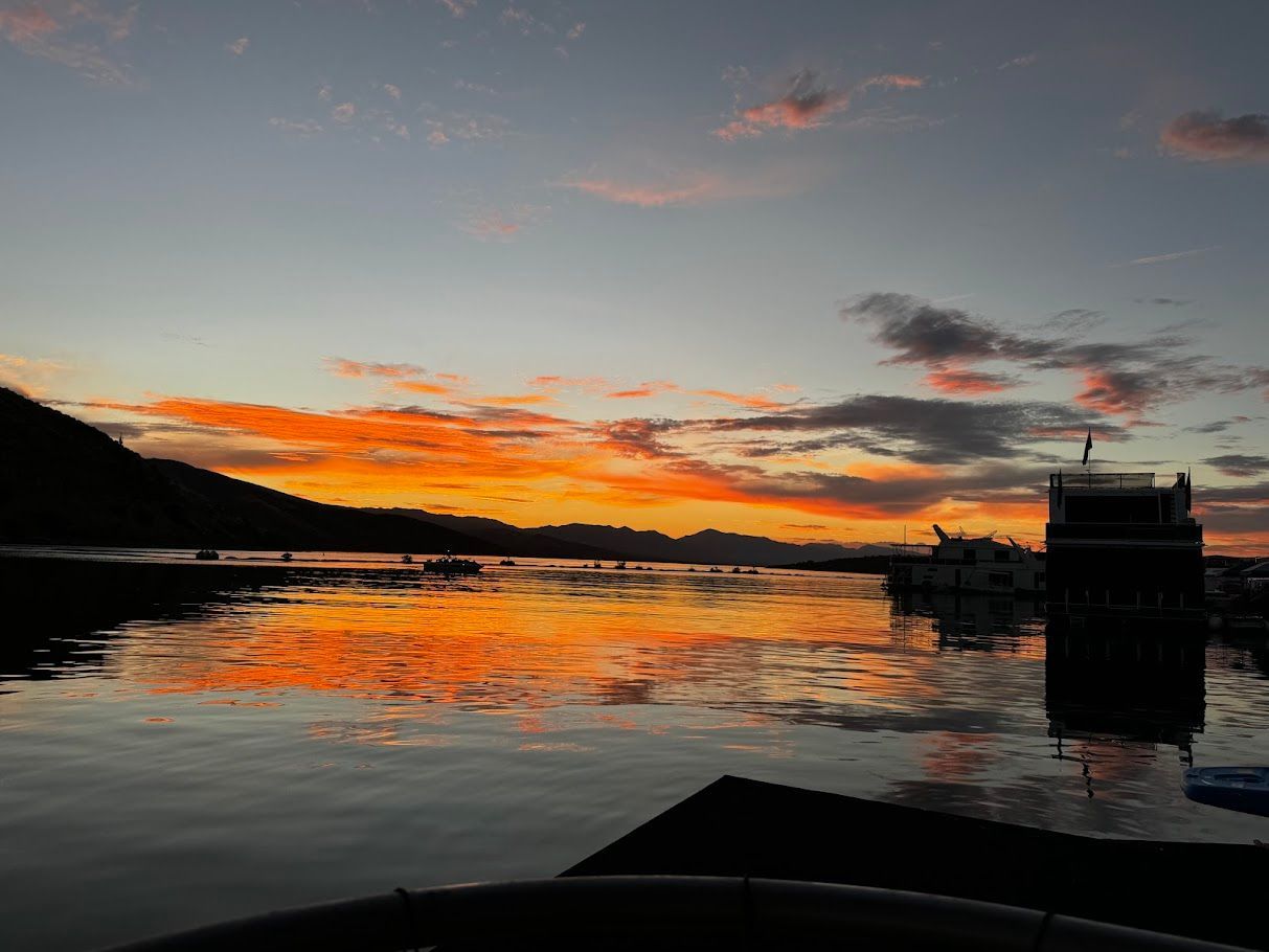 Sunset over lake with Summersun houseboats, model 16x68, year 2006.