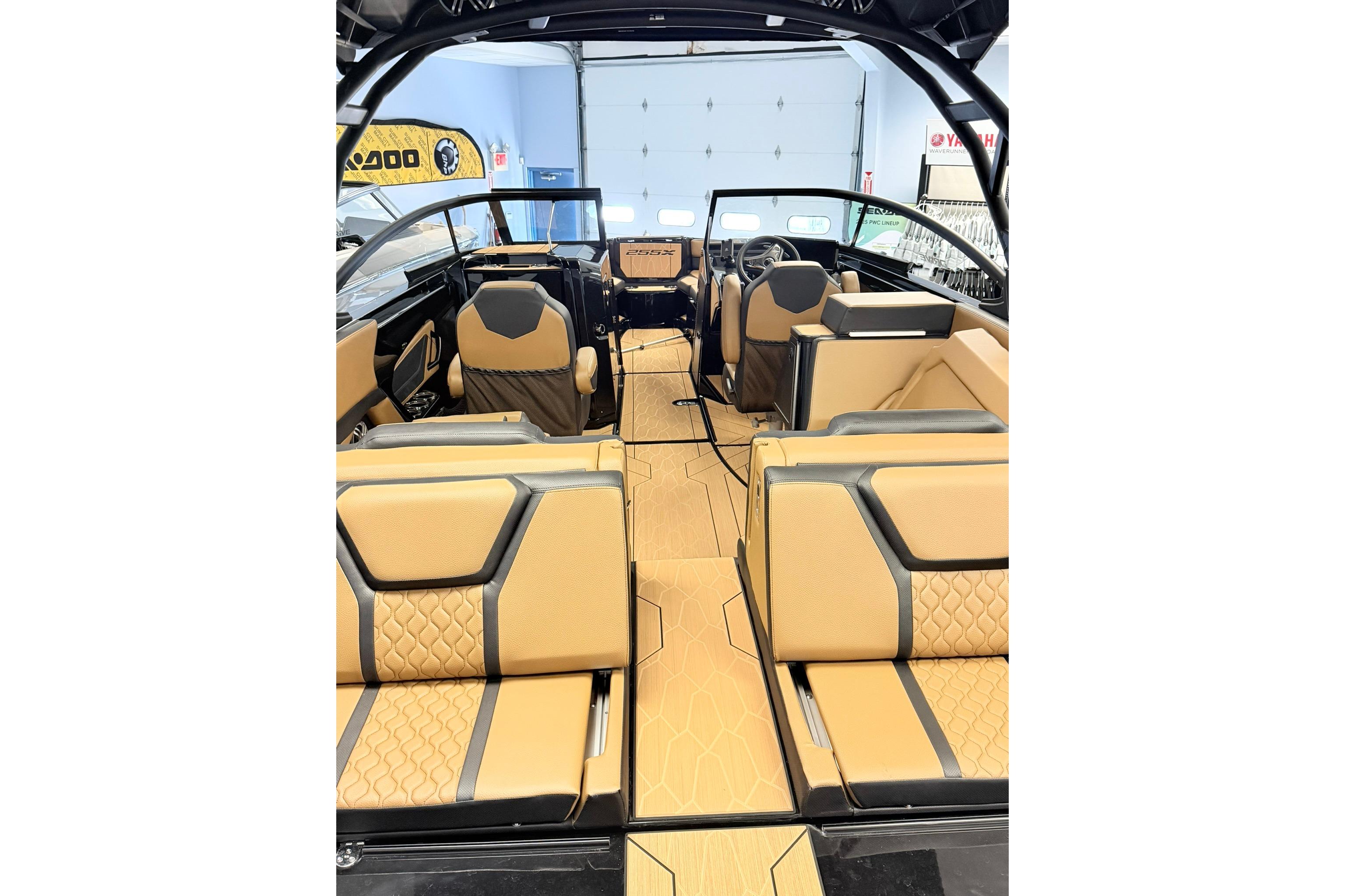 Interior view of 2026 Yamaha Boats 255XD, featuring luxurious tan and black seating.