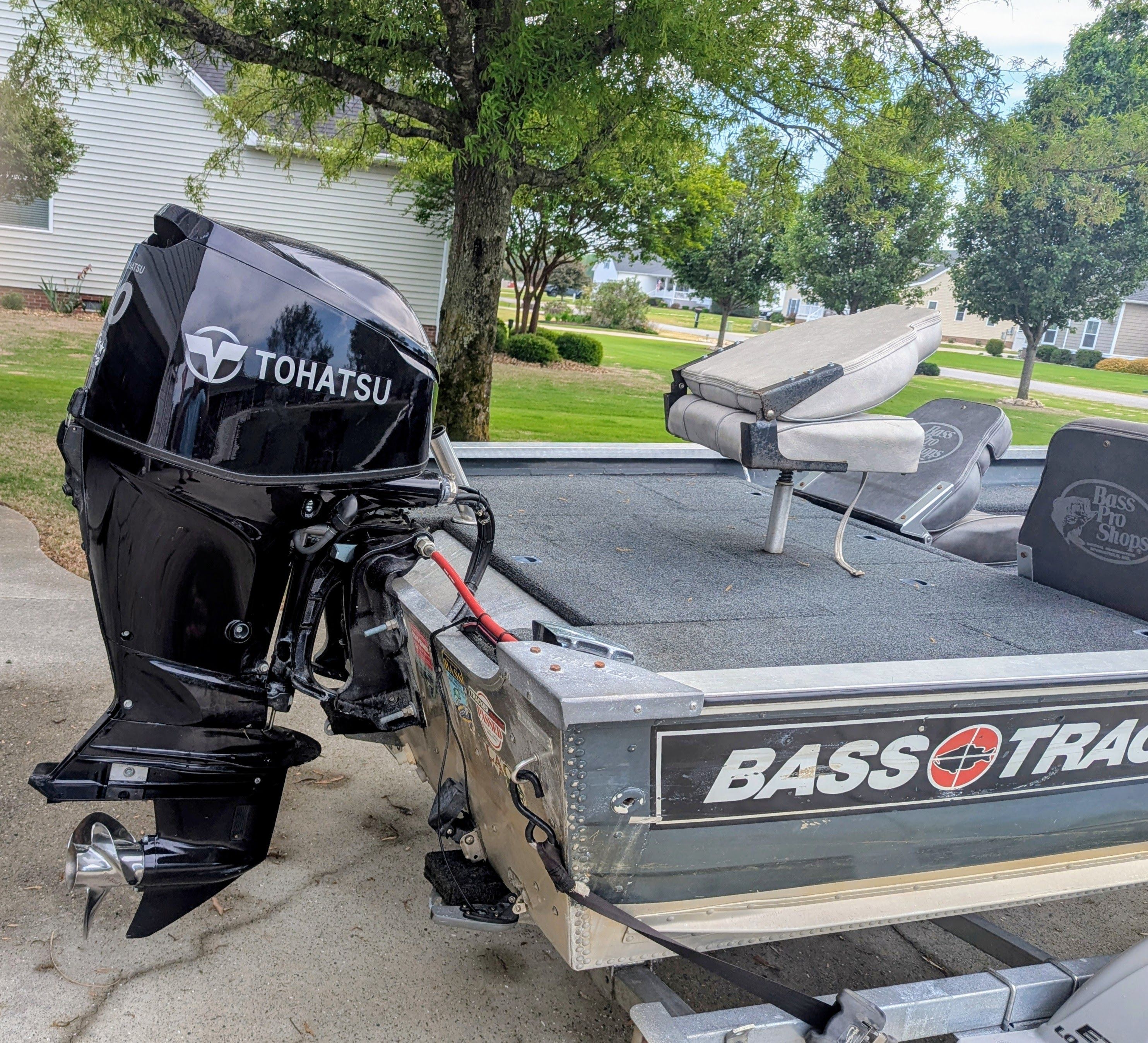 A 1988 Bass Tracker Tournament V with a Tohatsu outboard motor, parked on a trailer.