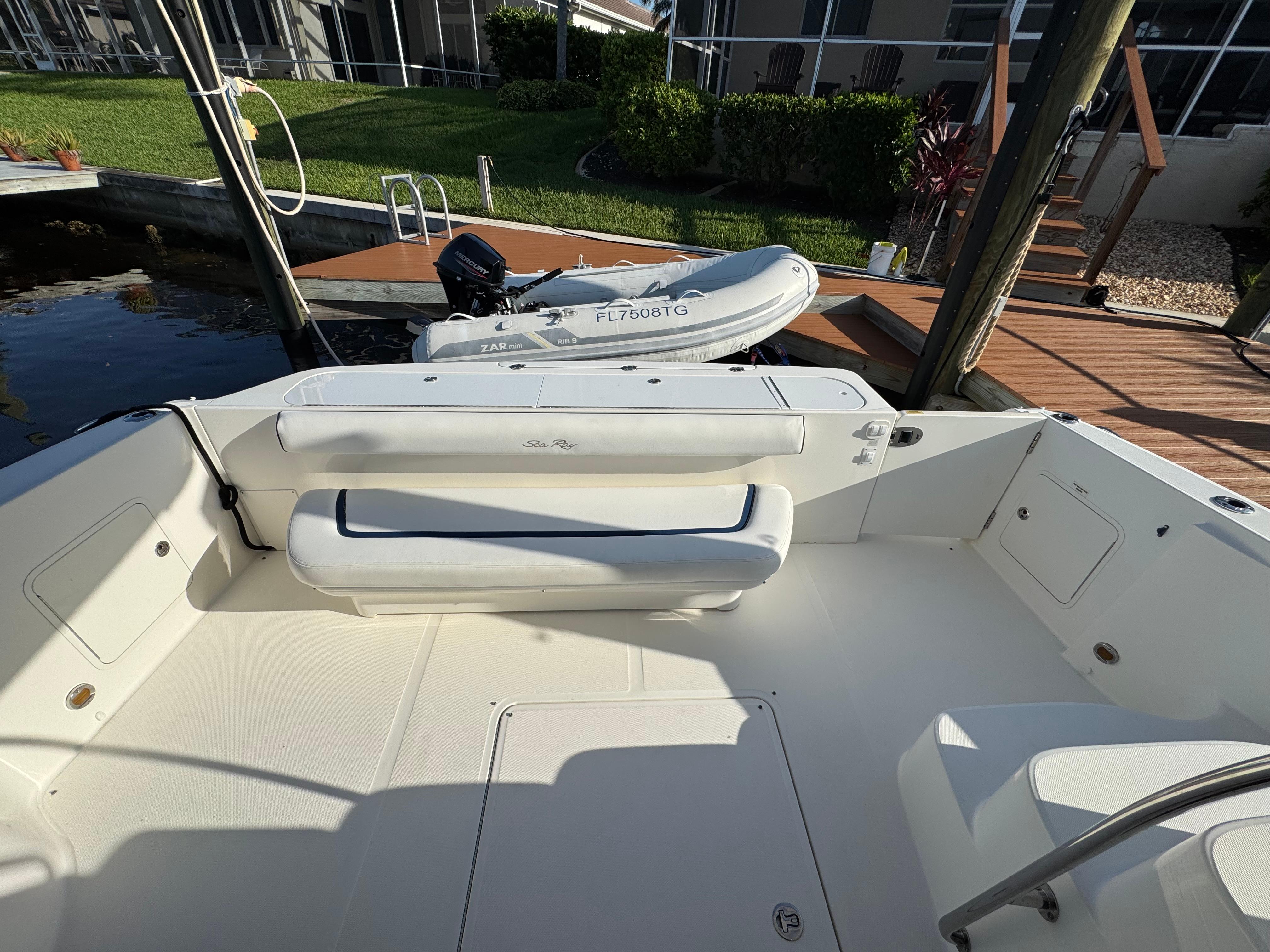 2007 Sea Ray 52 Sedan Bridge yacht deck with seating and docked inflatable boat.