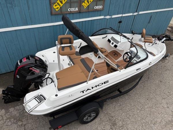 2025 Tahoe 185 S boat with tan seating and black motor, parked on trailer.