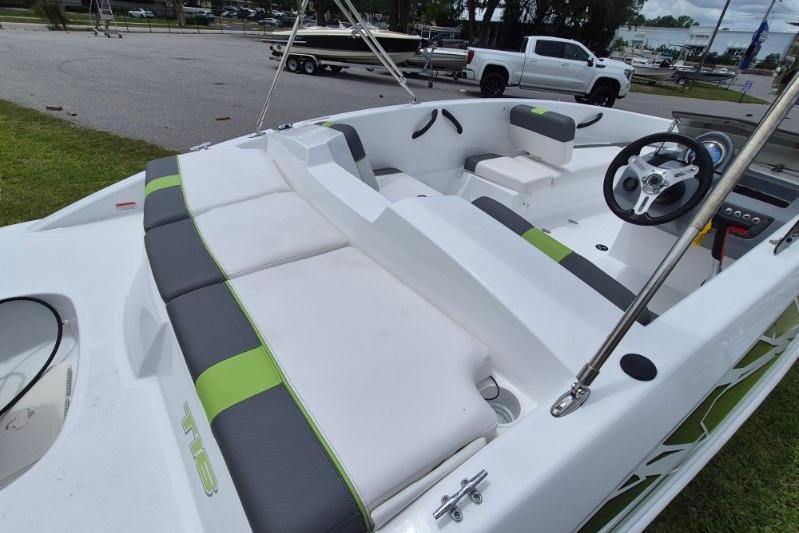 2021 Tahoe T16 boat interior with white and green seating, steering wheel, and dashboard.
