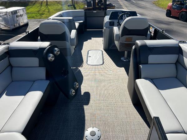 Interior of a 2023 Viaggio Lago 22U Tri Toon with gray seating and steering wheel.