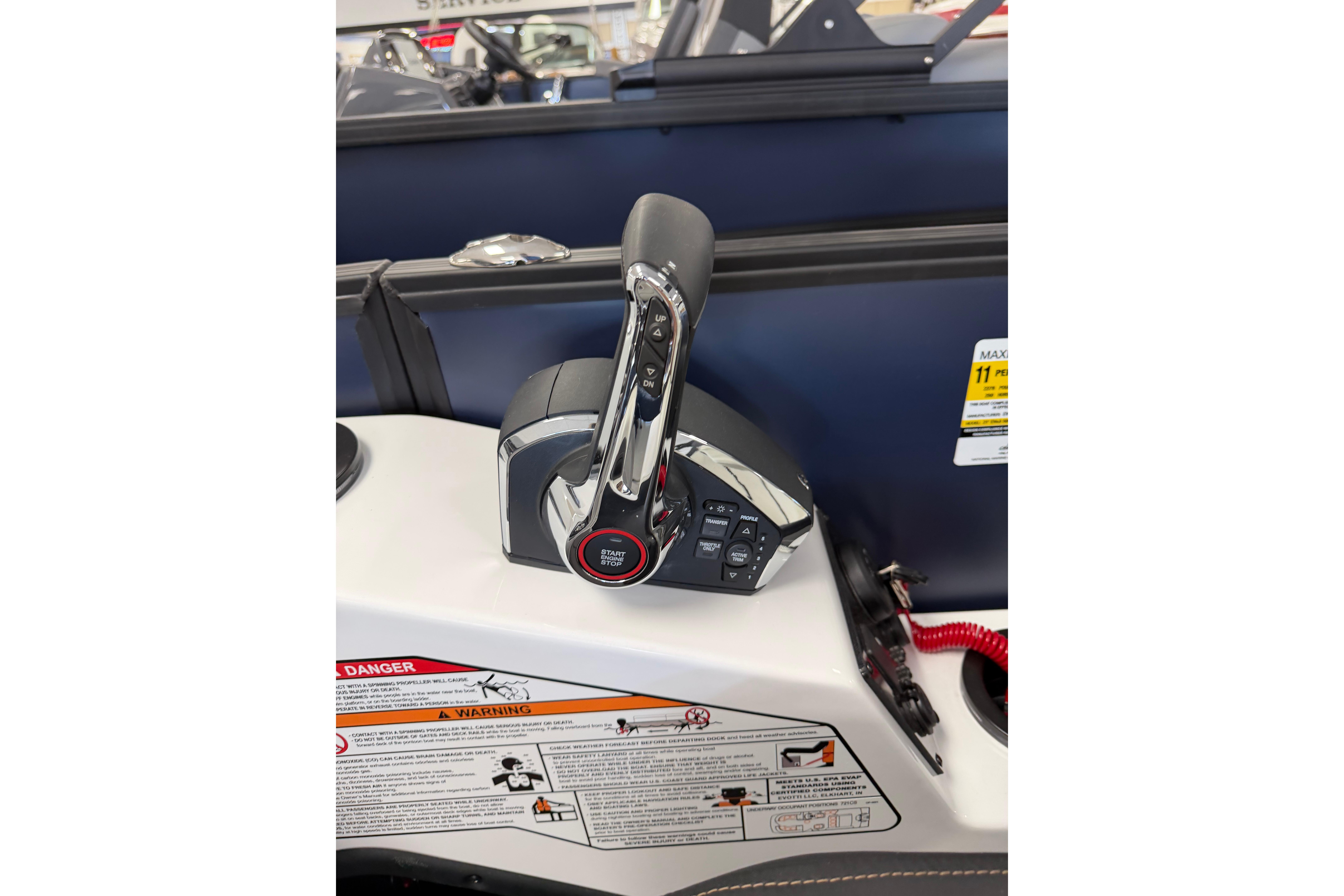 Control panel of 2026 Evotti 721CS boat with start/stop button and throttle lever.