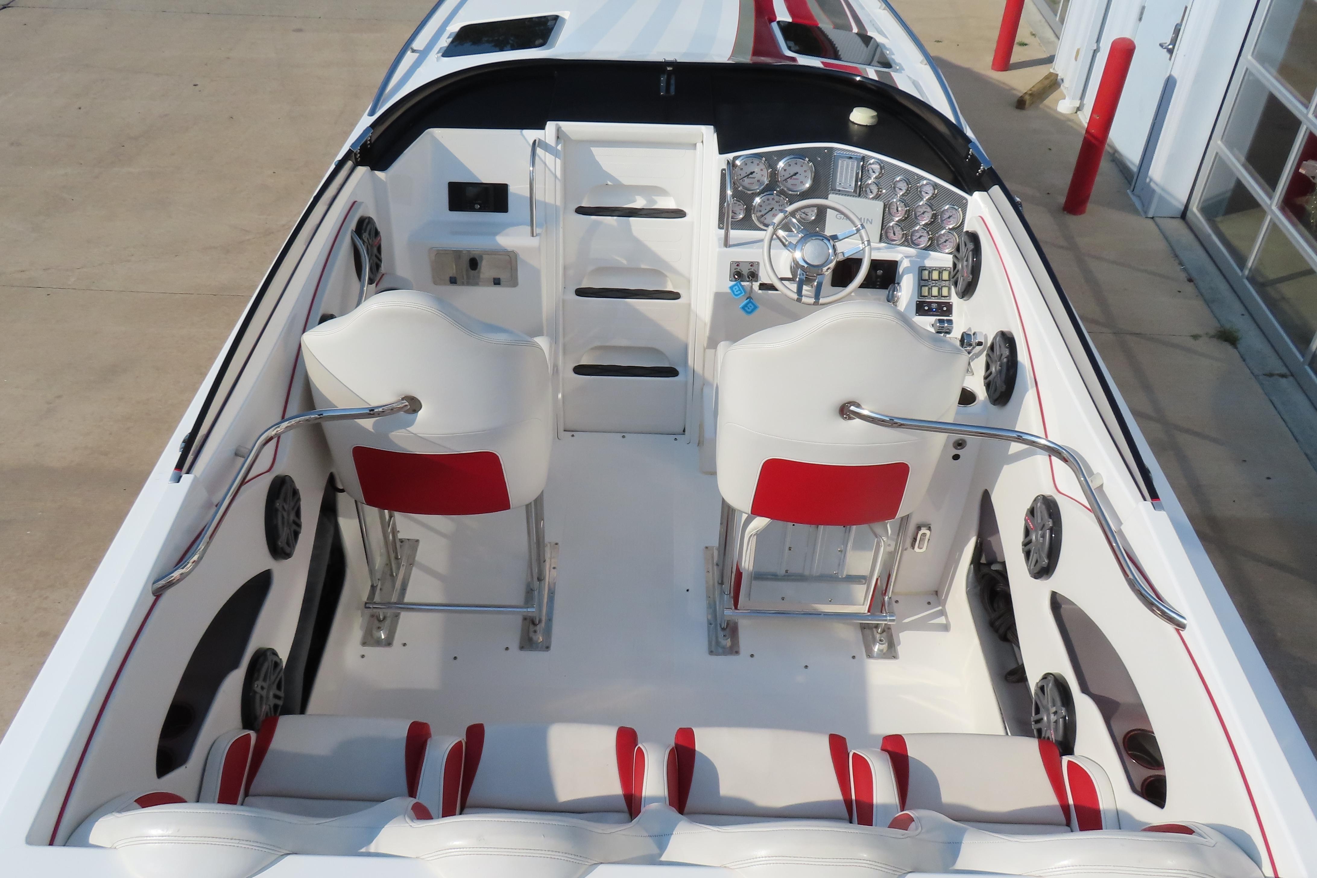 2013 Nordic 39 POKER RUN boat interior with white and red seating, modern dashboard.