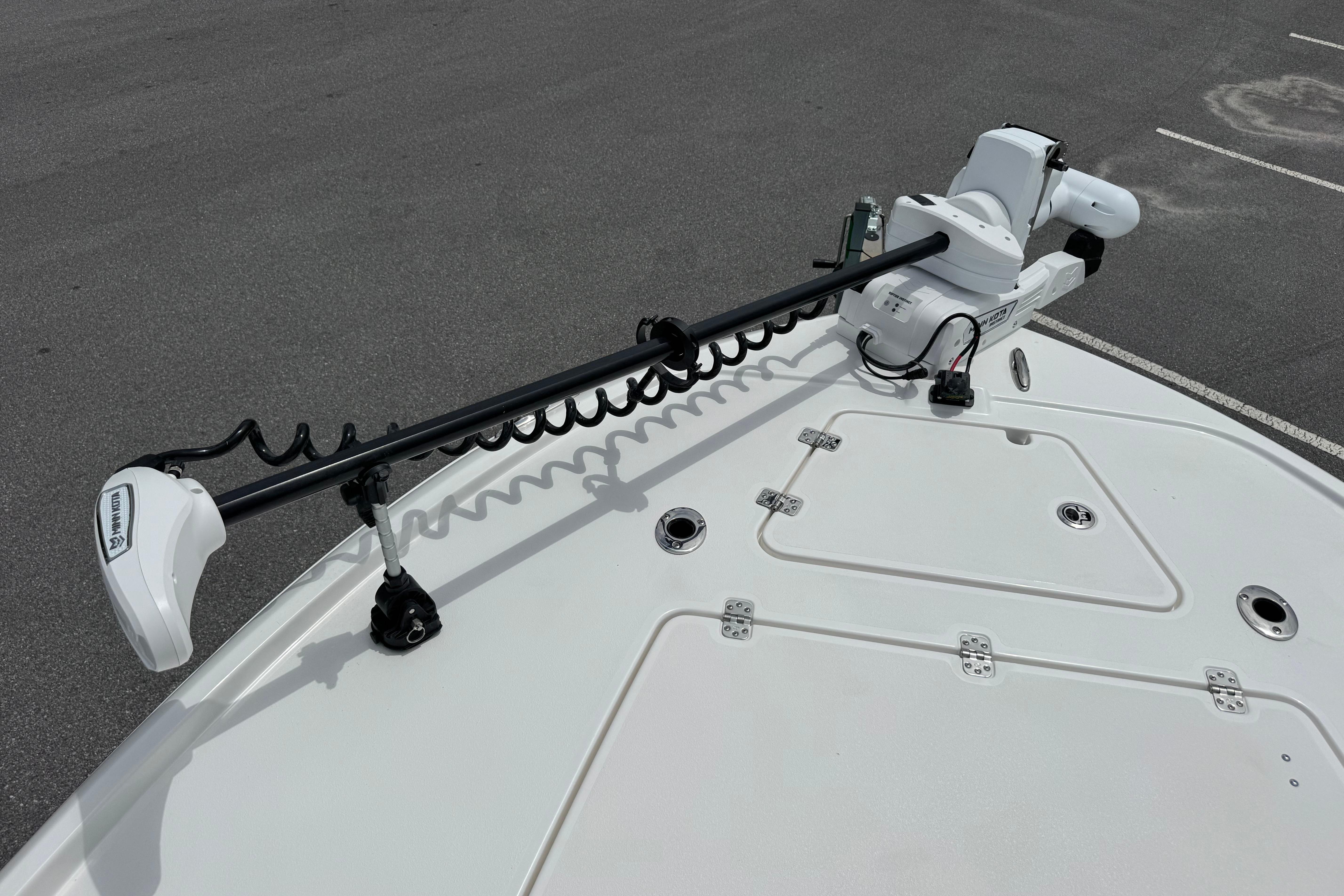 Bow of 2027 Caymas 26 HB boat with trolling motor and storage hatches.