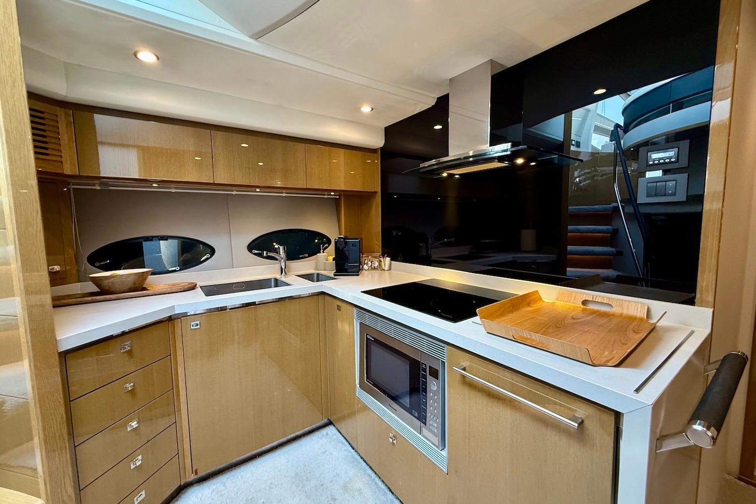 Luxurious kitchen interior of 2015 Princess V72 yacht with modern appliances and sleek design.