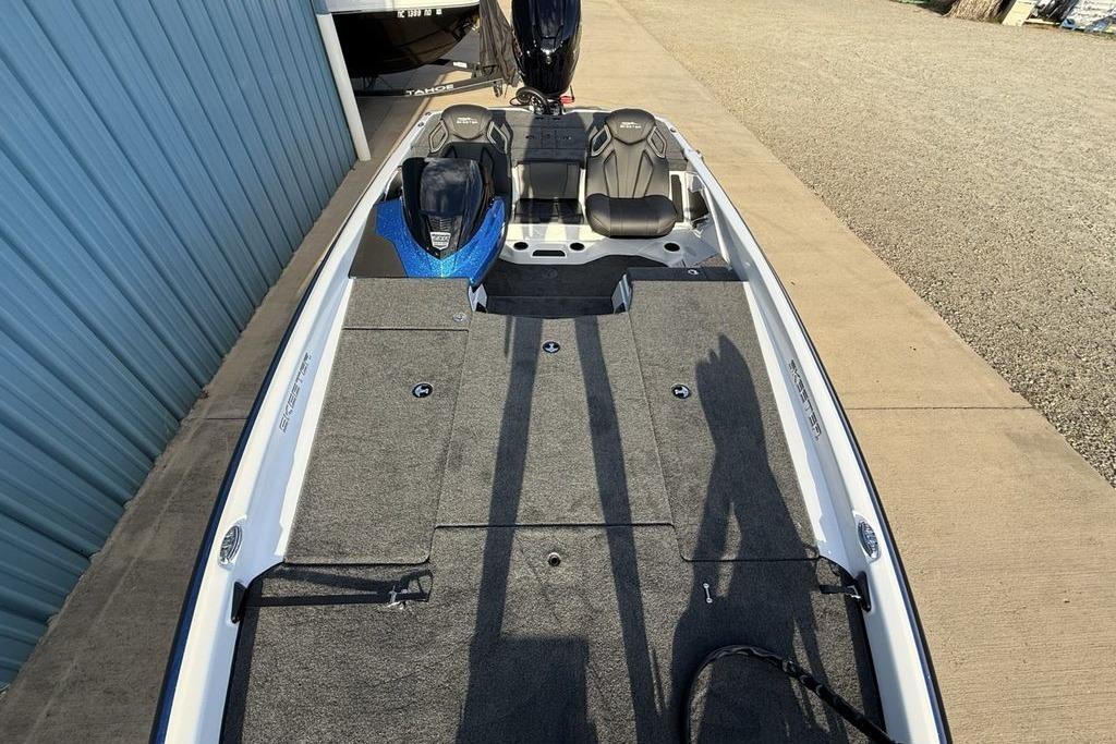 2026 Skeeter ZXR19 SE boat with spacious deck and dual seats, parked near blue building.