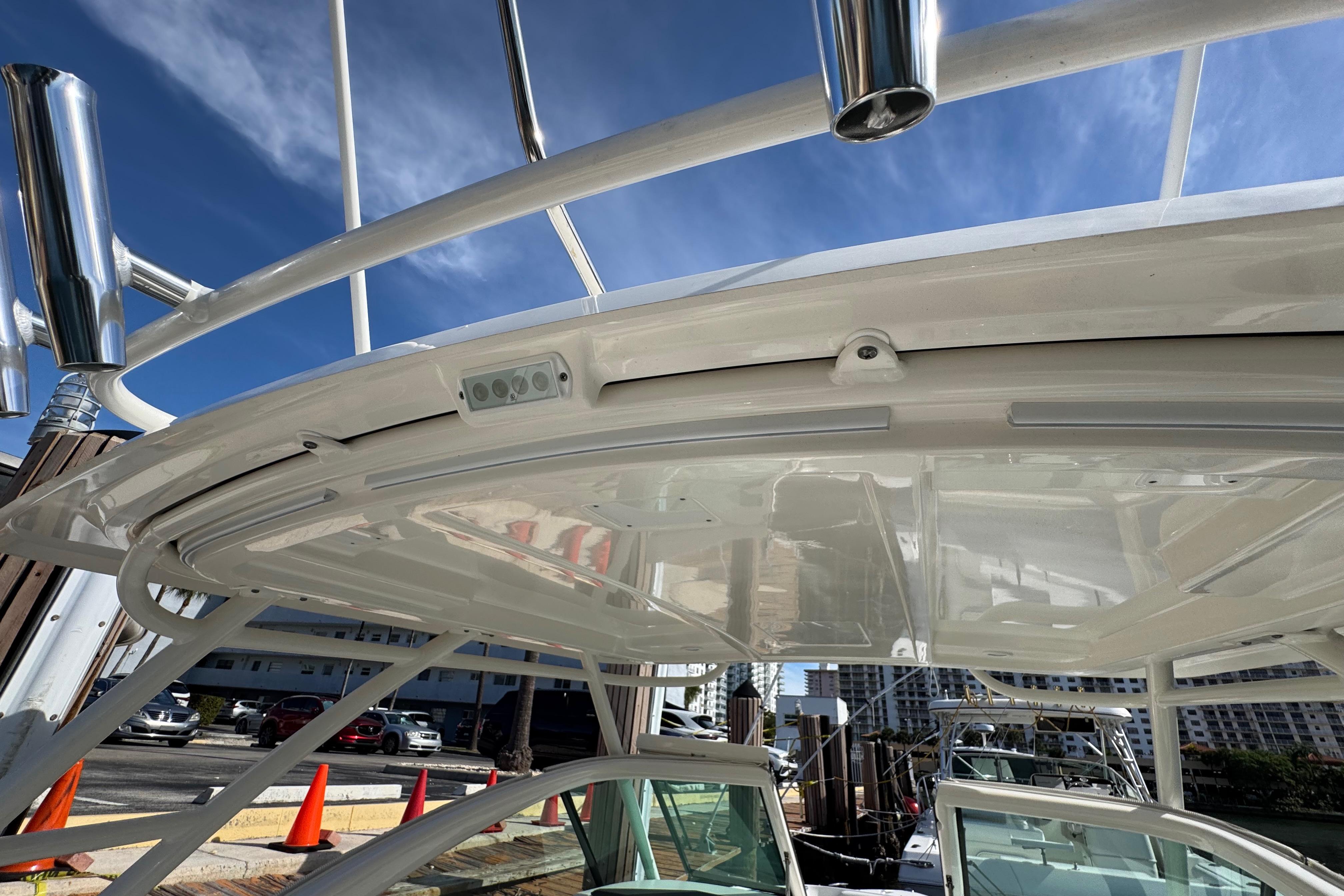 2022 Pursuit DC 266 Dual Console boat with sleek white hardtop and rod holders.