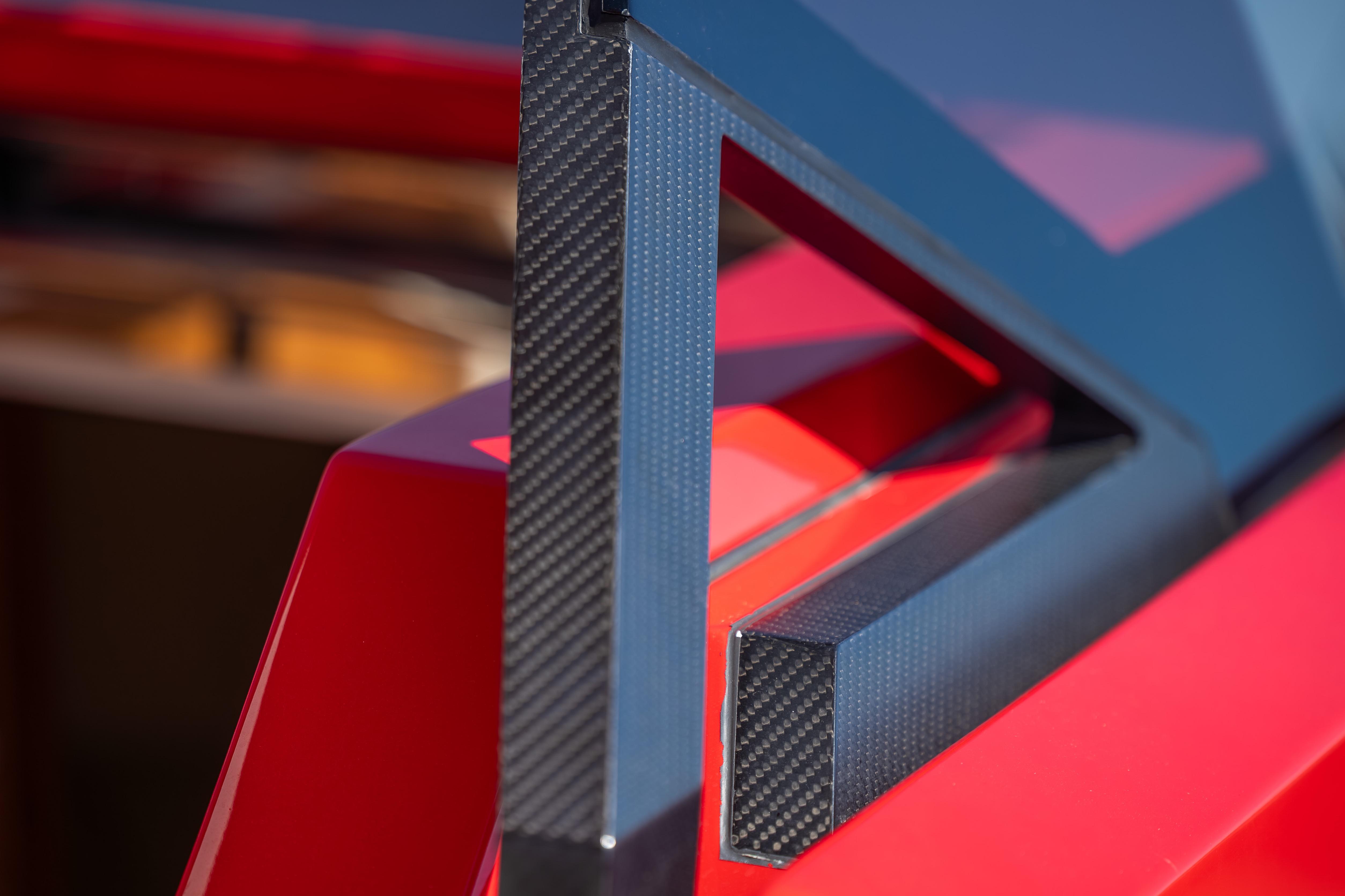 Close-up of 2021 Wally 48 yacht's sleek, modern carbon fiber and red design elements.