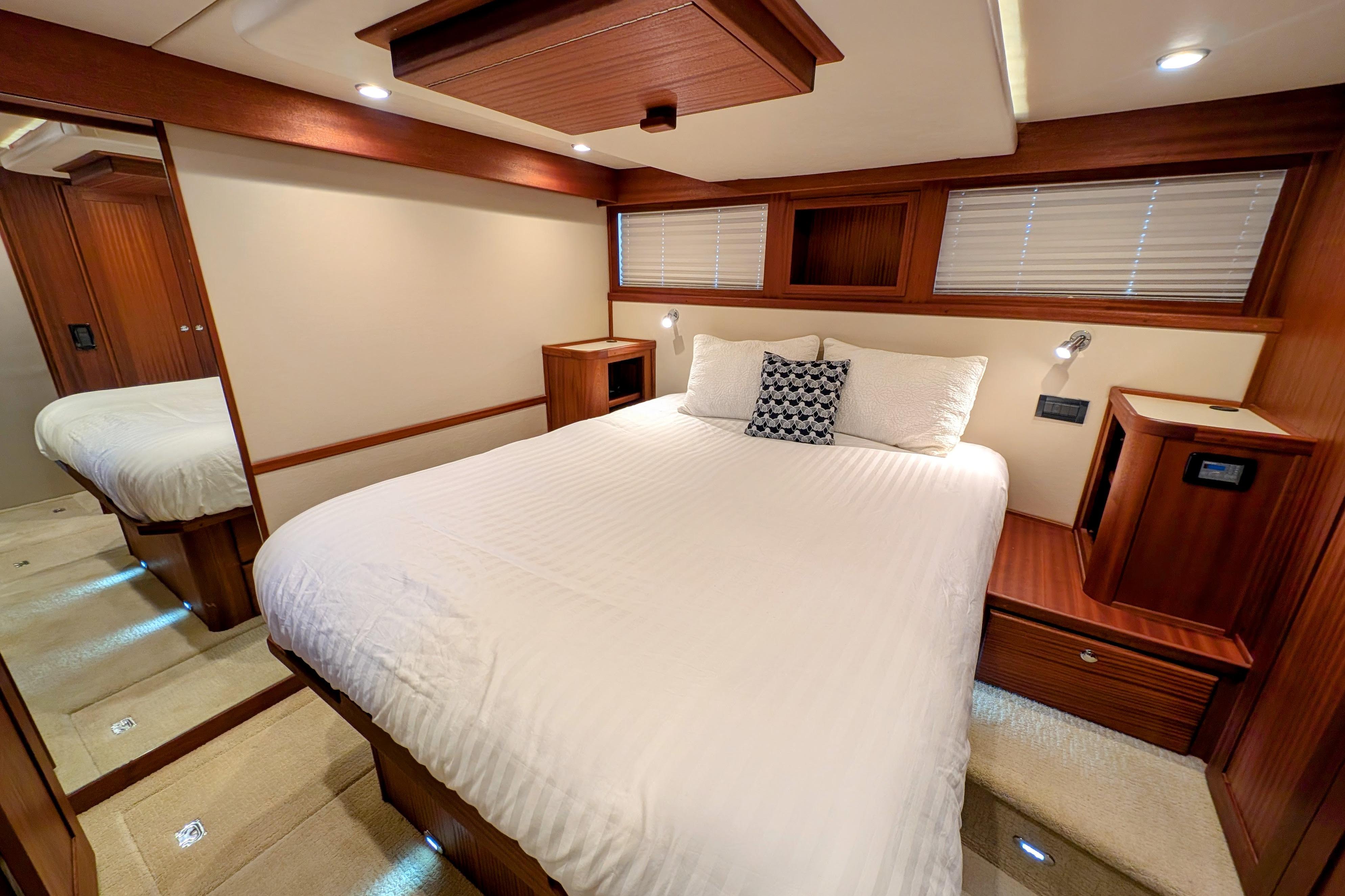 Luxurious bedroom interior of 2015 American Tug 435 with elegant wood finishes.