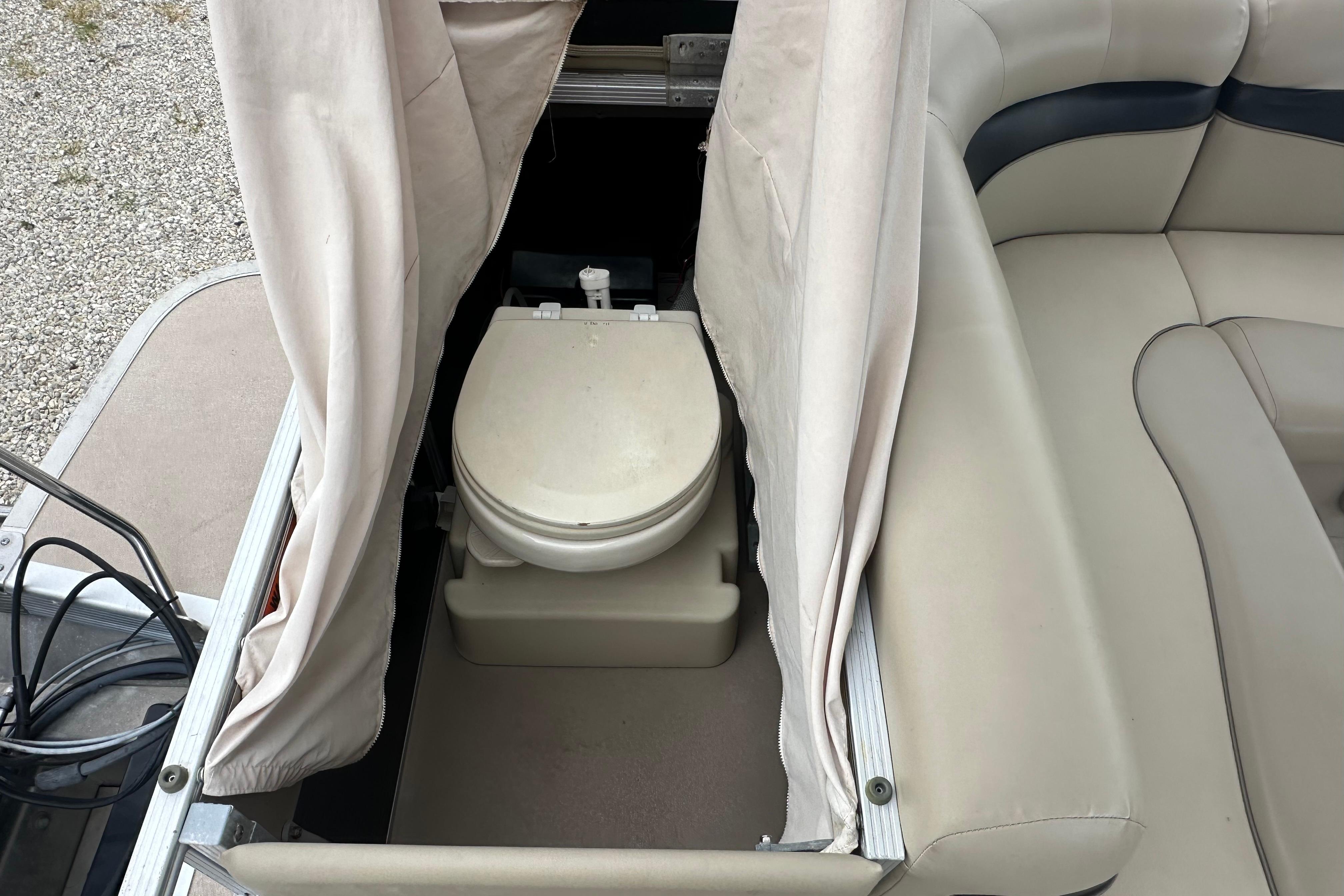 2014 Bennington S22 boat with onboard portable toilet and privacy curtain.