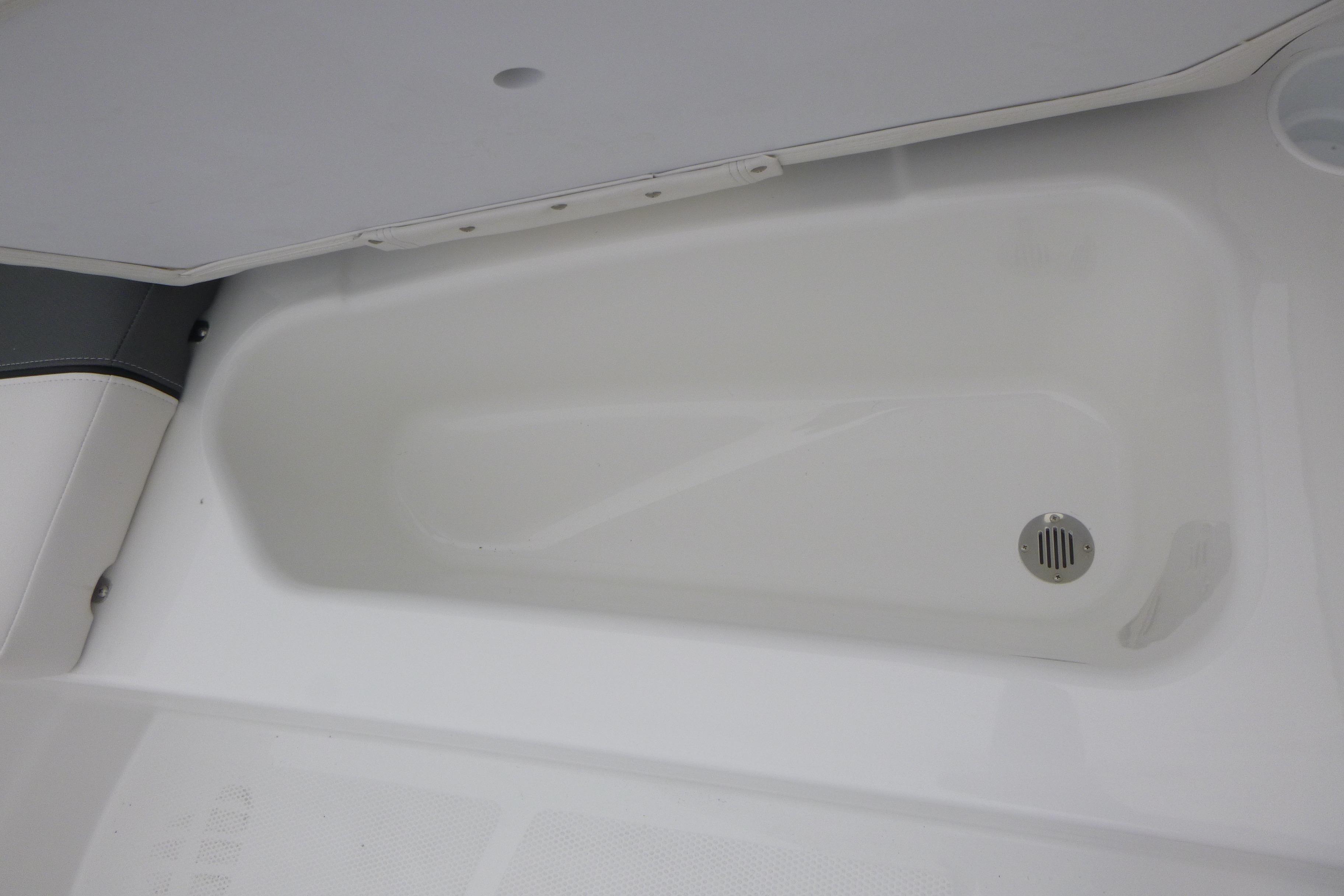 2026 Tahoe T16 boat storage compartment with drain, featuring sleek white interior design.