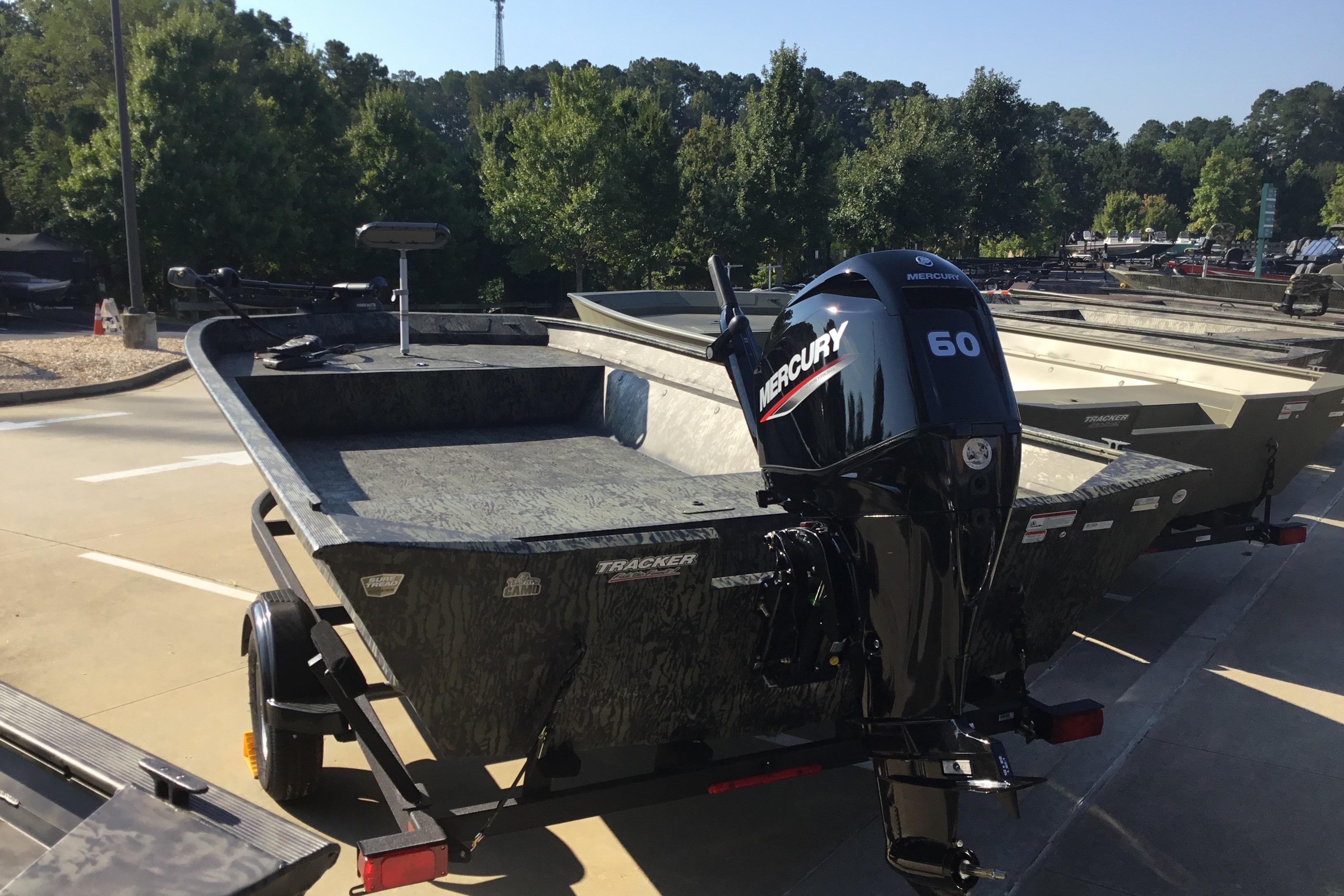 2025 Tracker Grizzly 2072 Utility boat with Mercury 60 engine, parked outdoors.