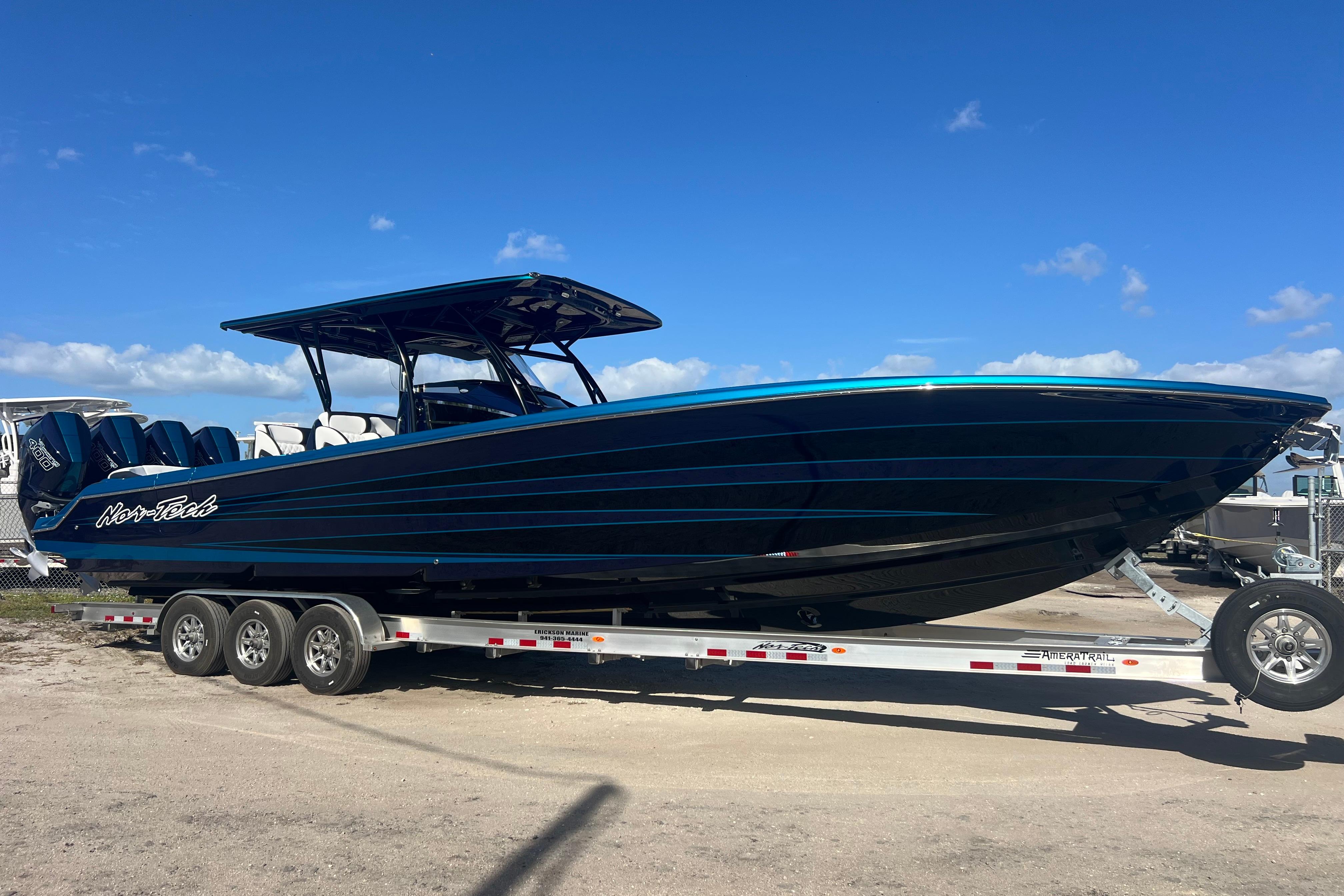 2026 Nor-Tech 390 Sport Center Console boat on trailer under clear blue sky.