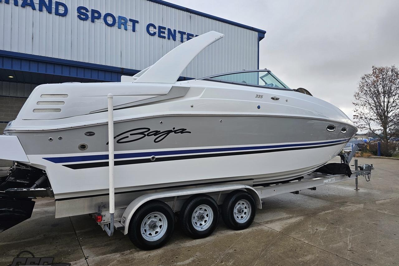 2008 Baja 335 Performance boat on trailer outside Grand Sport Center.