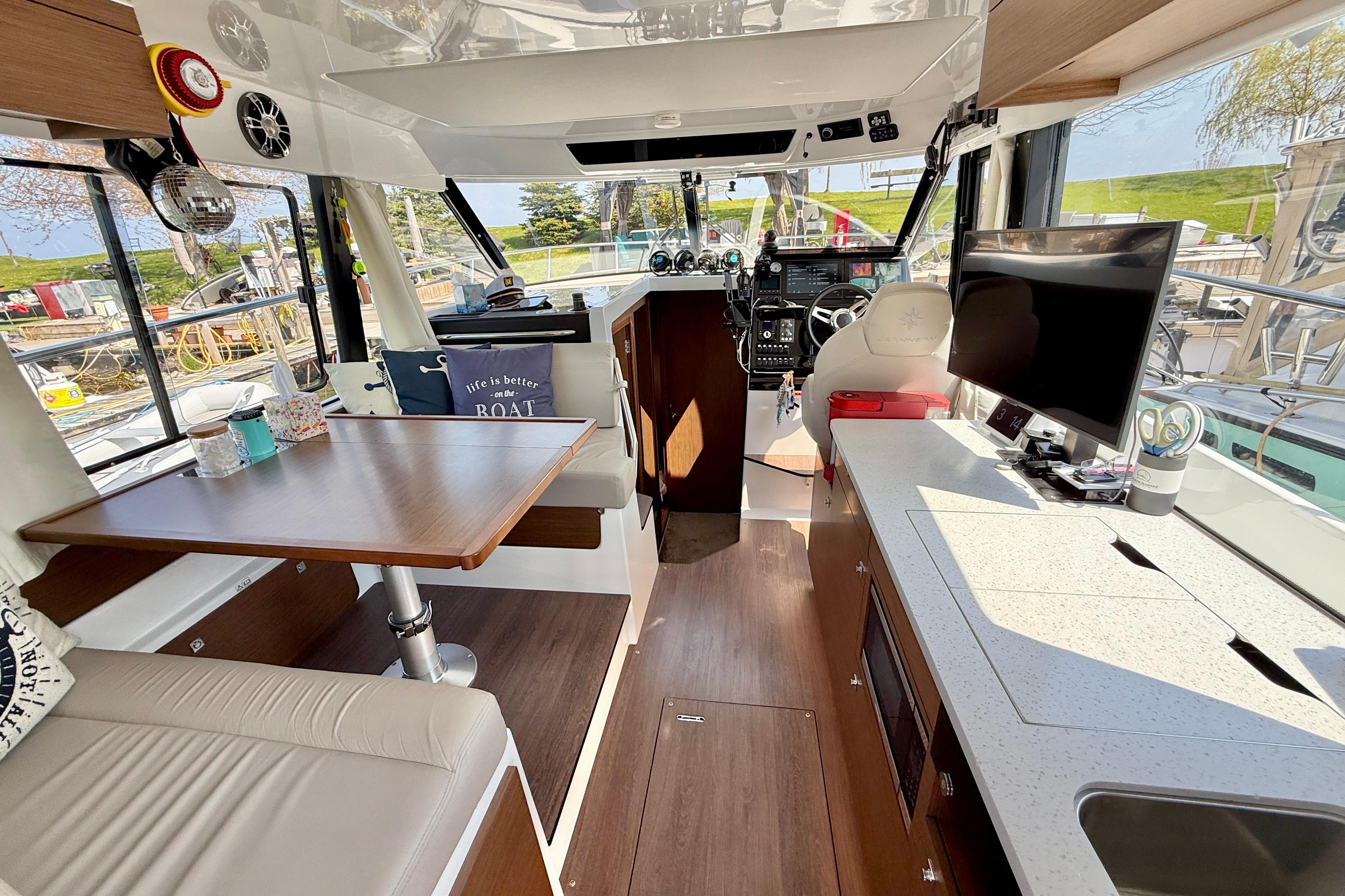 Interior of 2022 Jeanneau NC 1095 Fly boat with modern amenities and seating area.