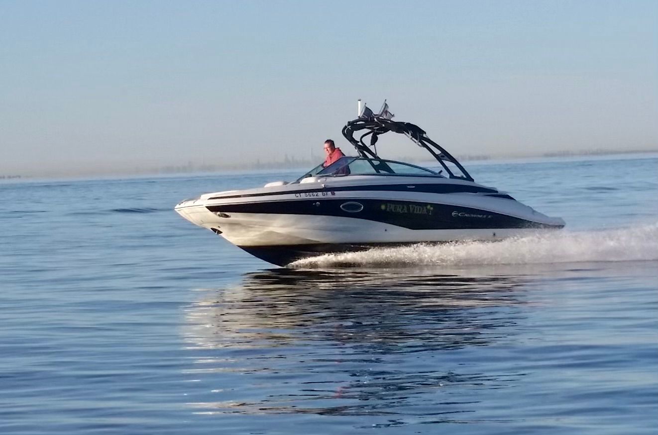 A 2013 Crownline E-4 Bowrider cruising on calm water.