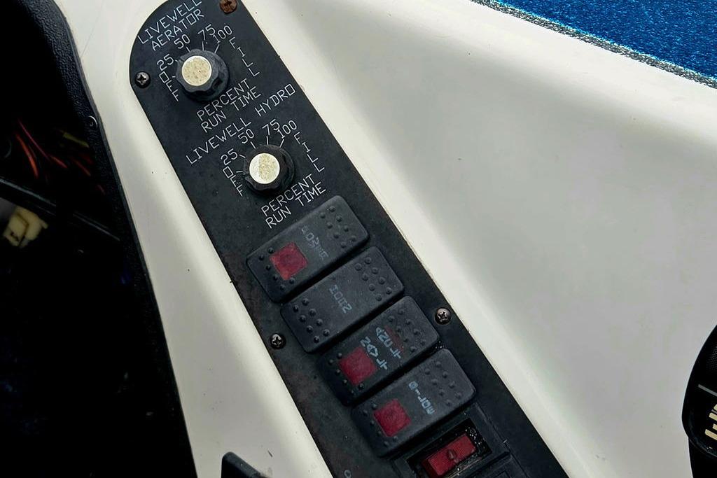 Control panel of a 1996 Champion 181 SX boat with switches and dials.