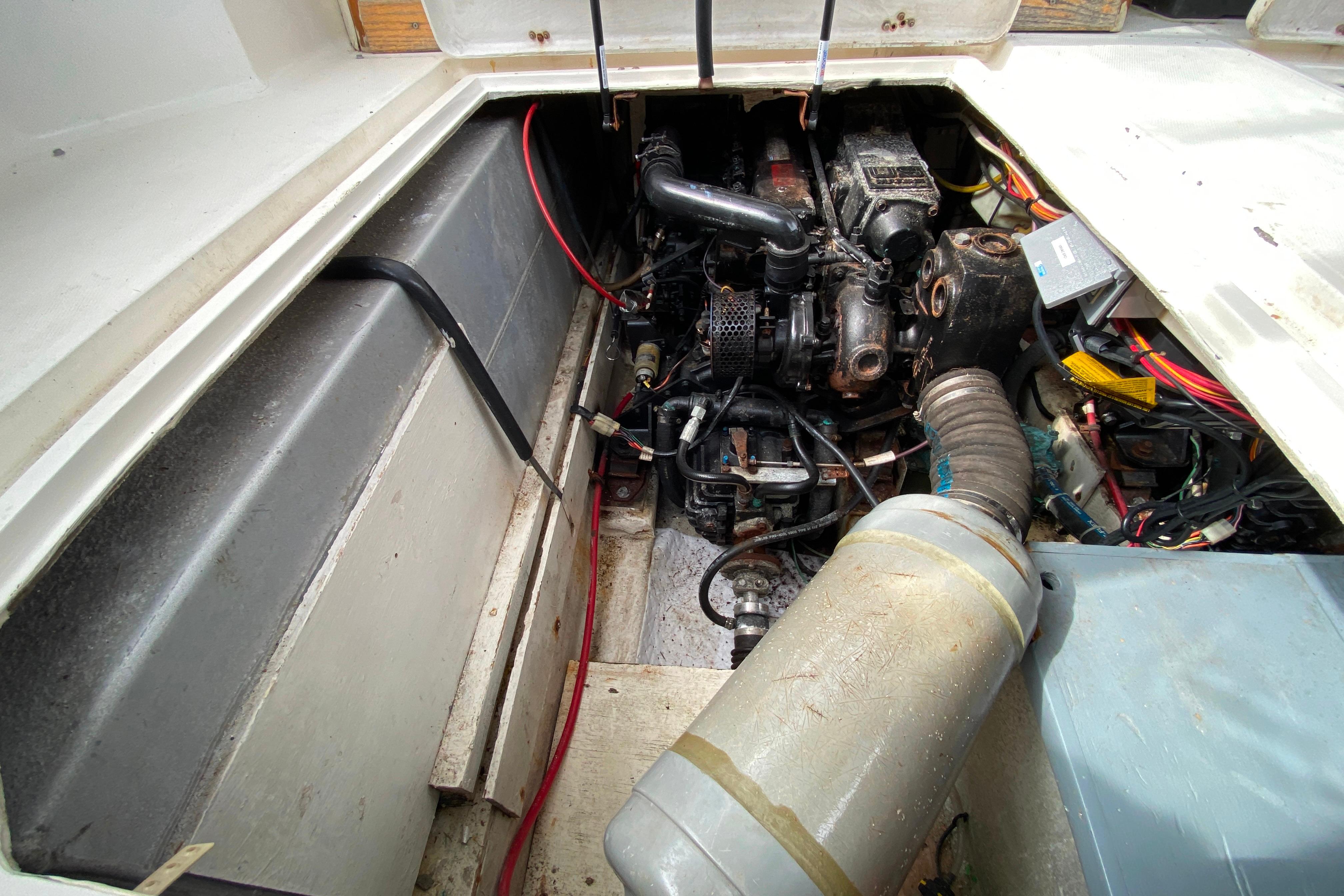 Engine compartment of a 1989 Bayliner 3288 Motoryacht, showcasing mechanical components and wiring.