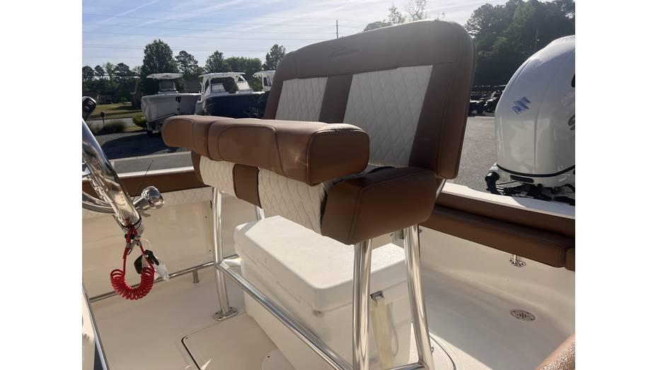 2025 Pioneer 202 Islander boat seat with brown and white upholstery, outdoor setting.