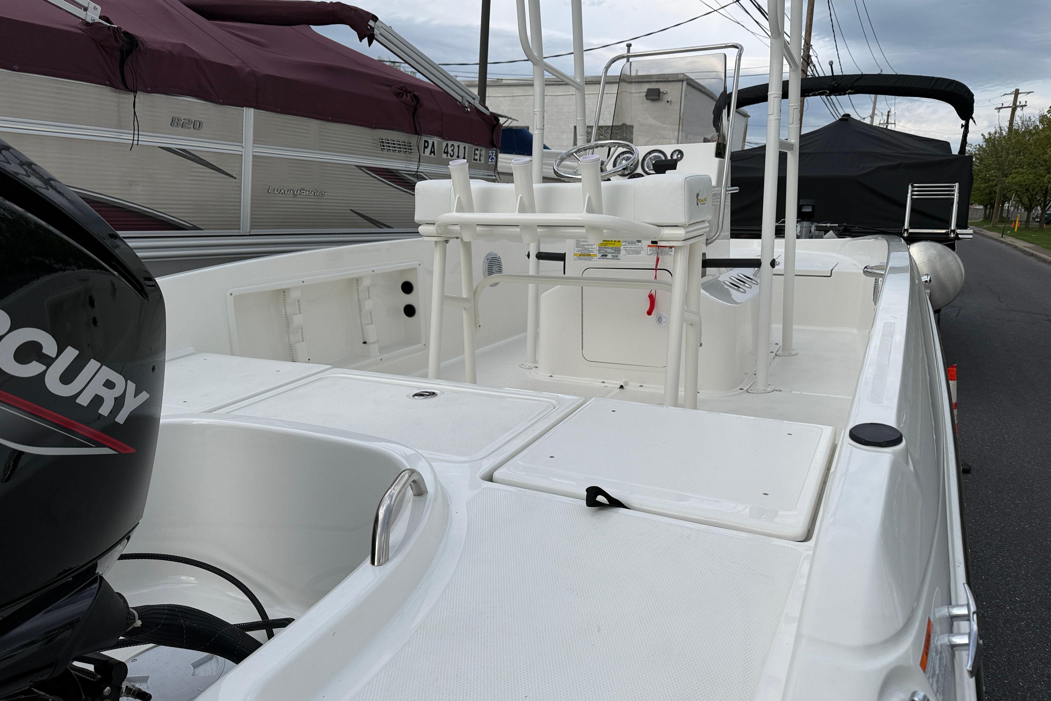 2026 Bayliner Trophy T18 boat with Mercury engine, docked outdoors.