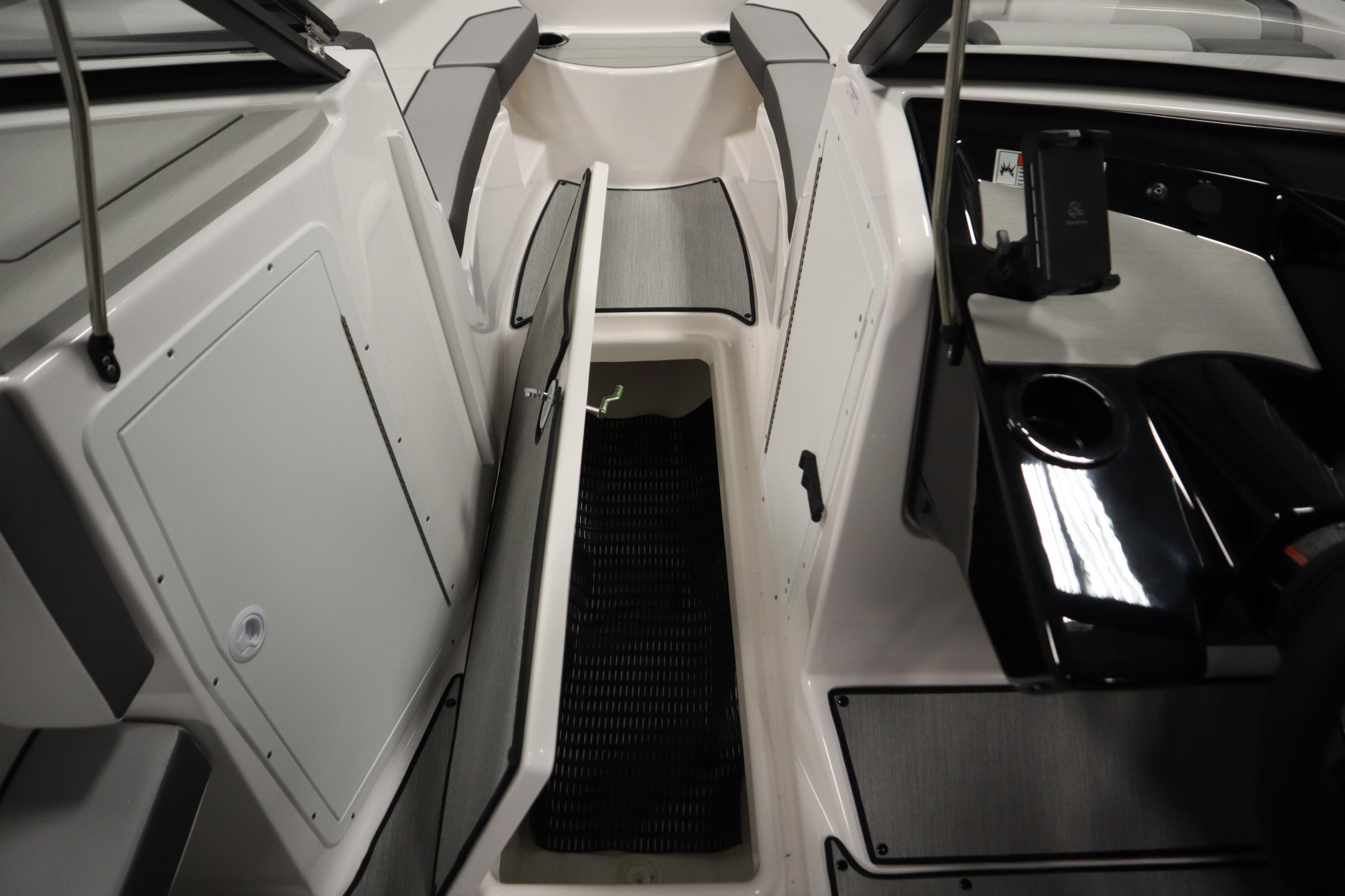 2026 Yamaha Boats AR220 interior with open storage compartment and sleek design.