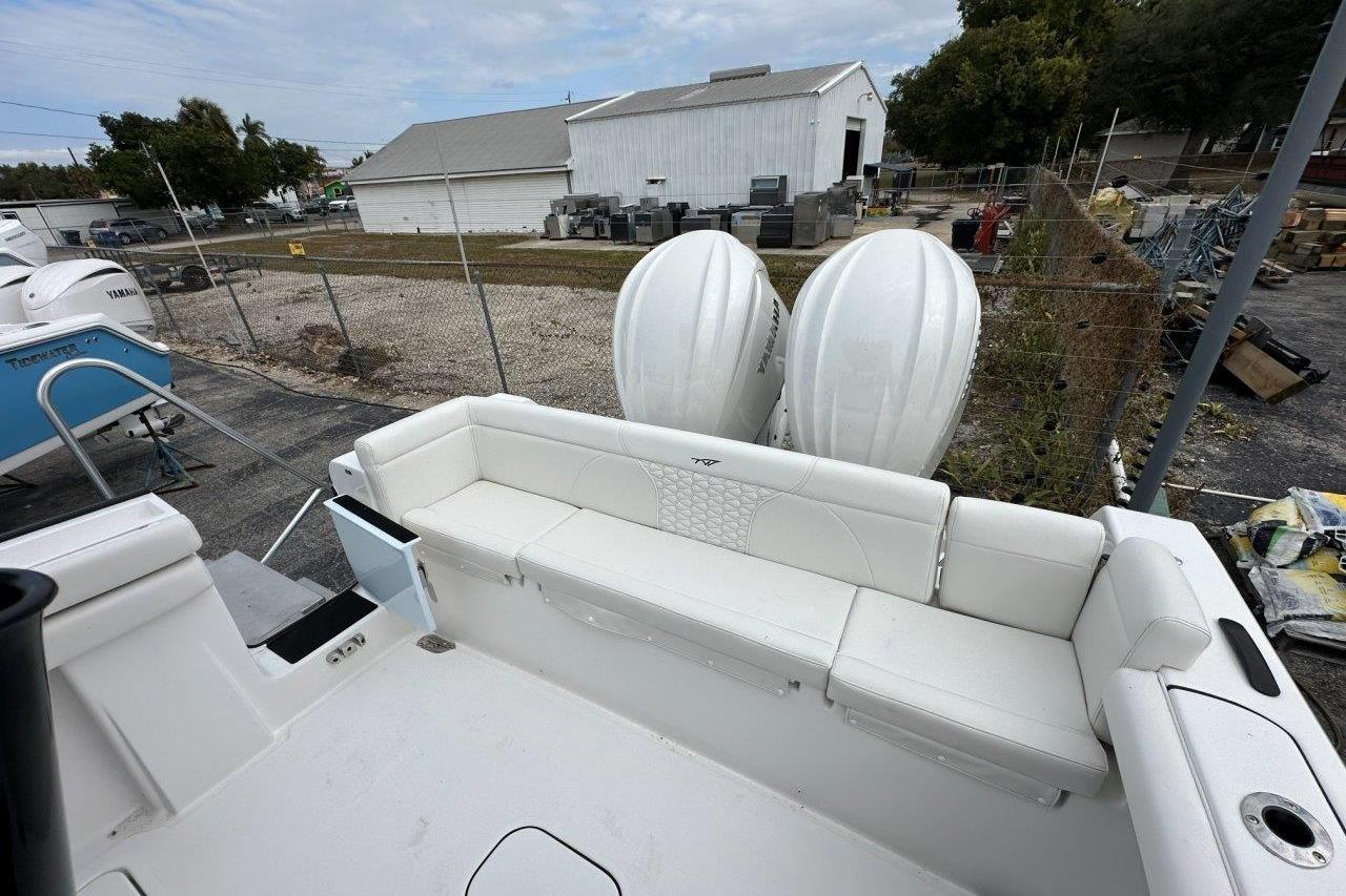 2026 Tidewater 272 LXF boat with white seating and dual outboard engines.