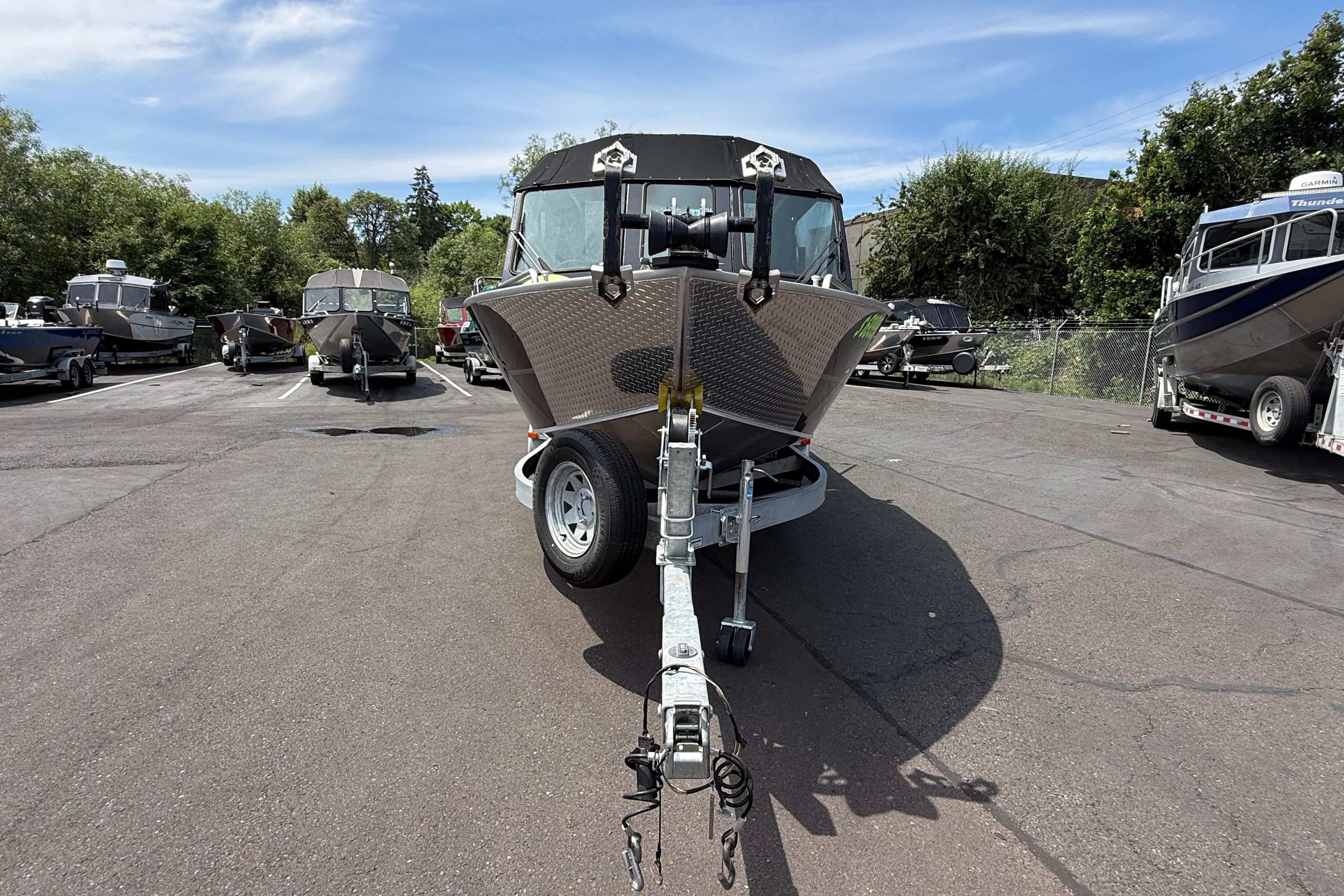 2019 Alumaweld Intruder Hard Top 22' boat on trailer in parking lot.
