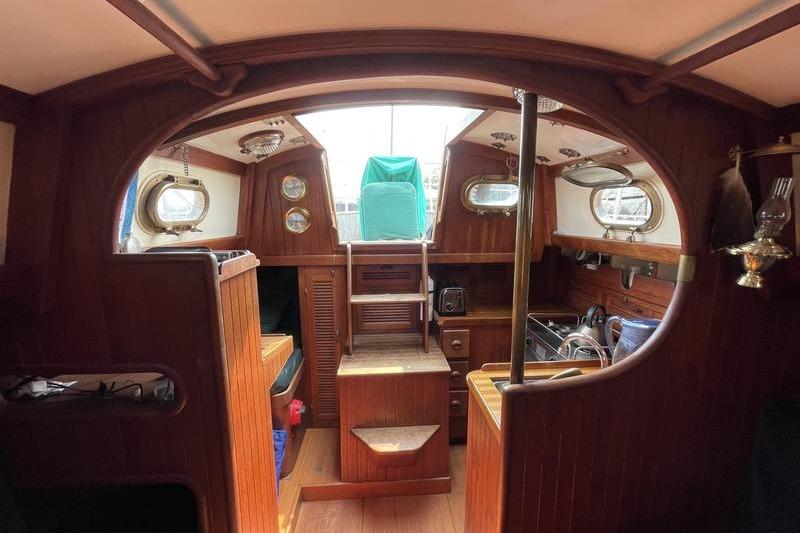 Interior of 1980 Ta Shing Baba 30 sailboat with wooden finishes and nautical decor.