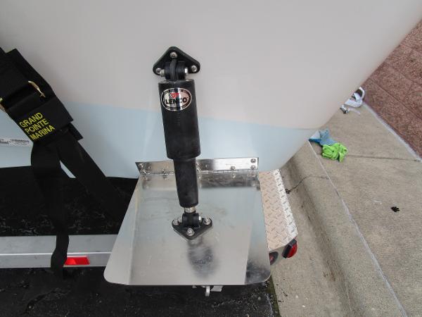 Close-up of 2024 Ranger 2360 Bay boat trim tab and shock absorber.