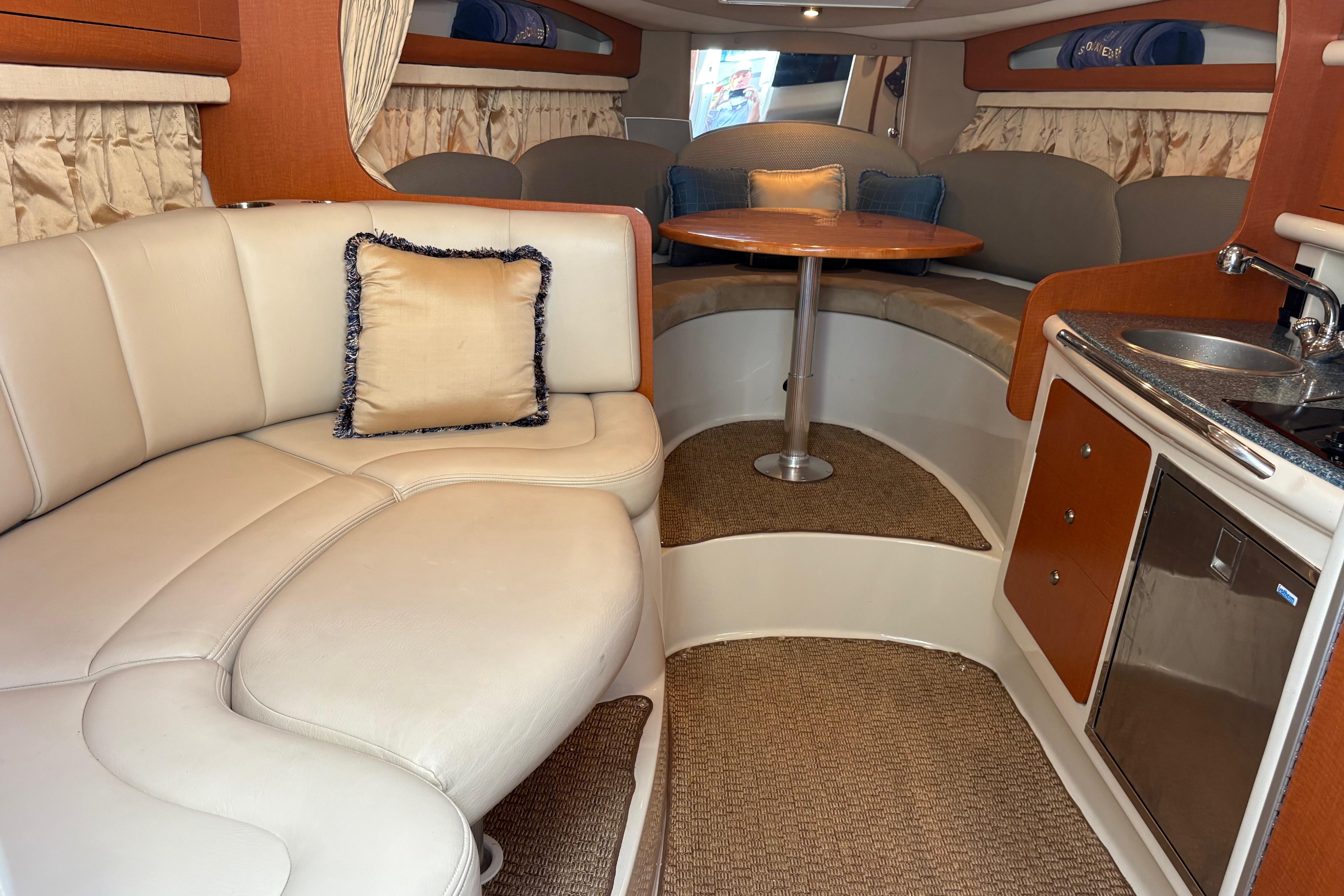 2005 Chaparral 290 Signature cabin interior with seating, table, and kitchenette.