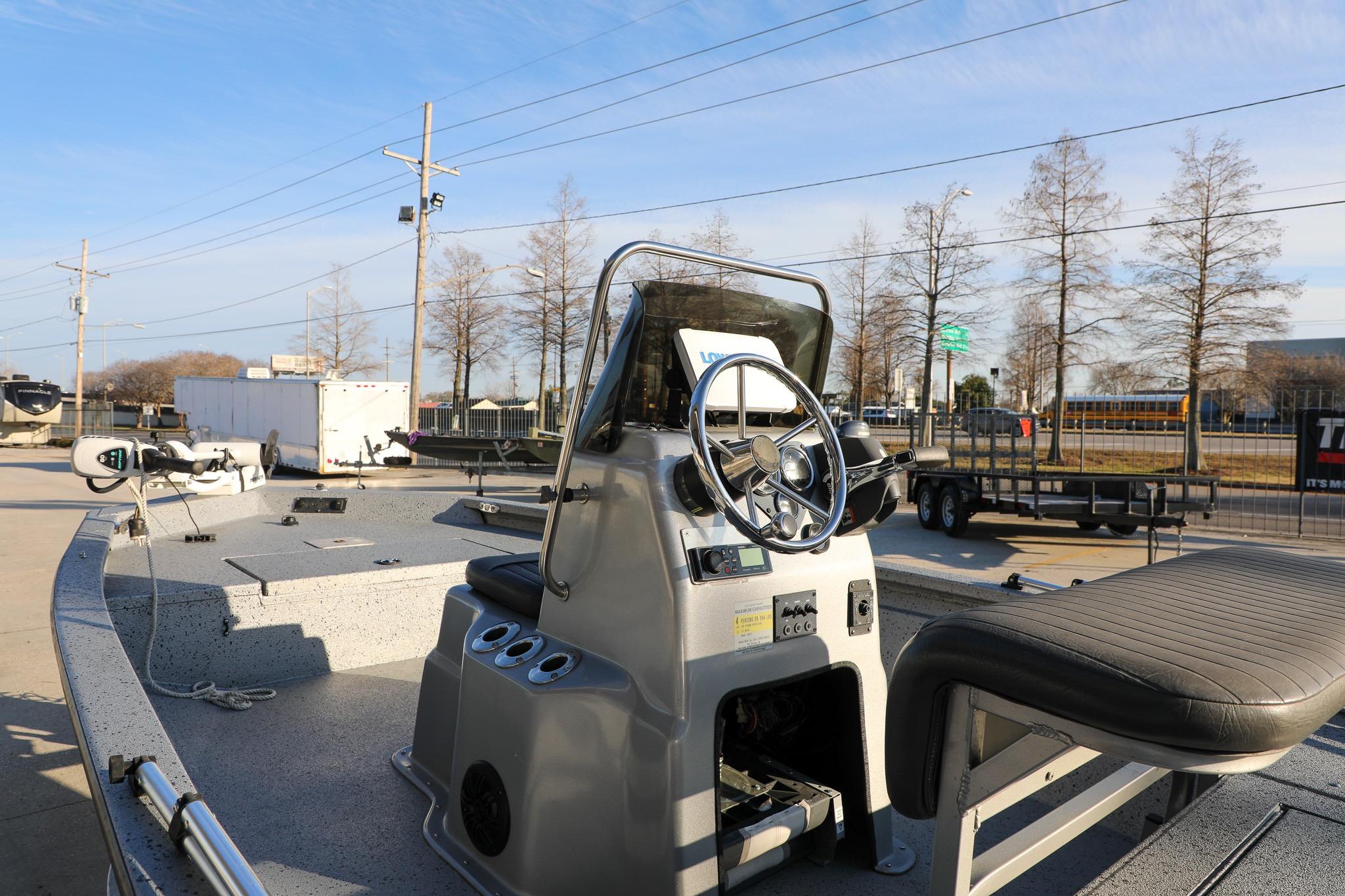 2019 Express 18 boat with steering console, parked outdoors under clear sky.