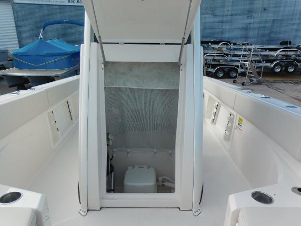 2025 Sailfish 232 CC boat interior with open hatch, revealing storage compartment.