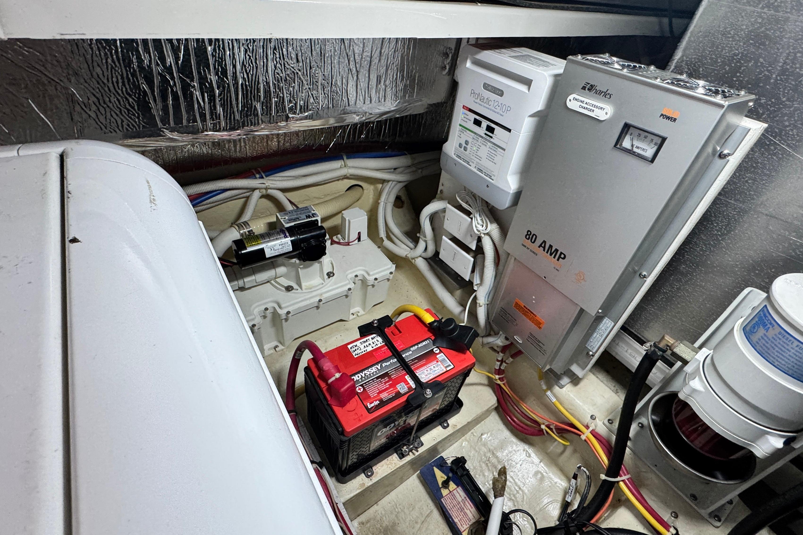 Engine room of 2007 Carver 47 Motor Yacht with battery and electrical systems.