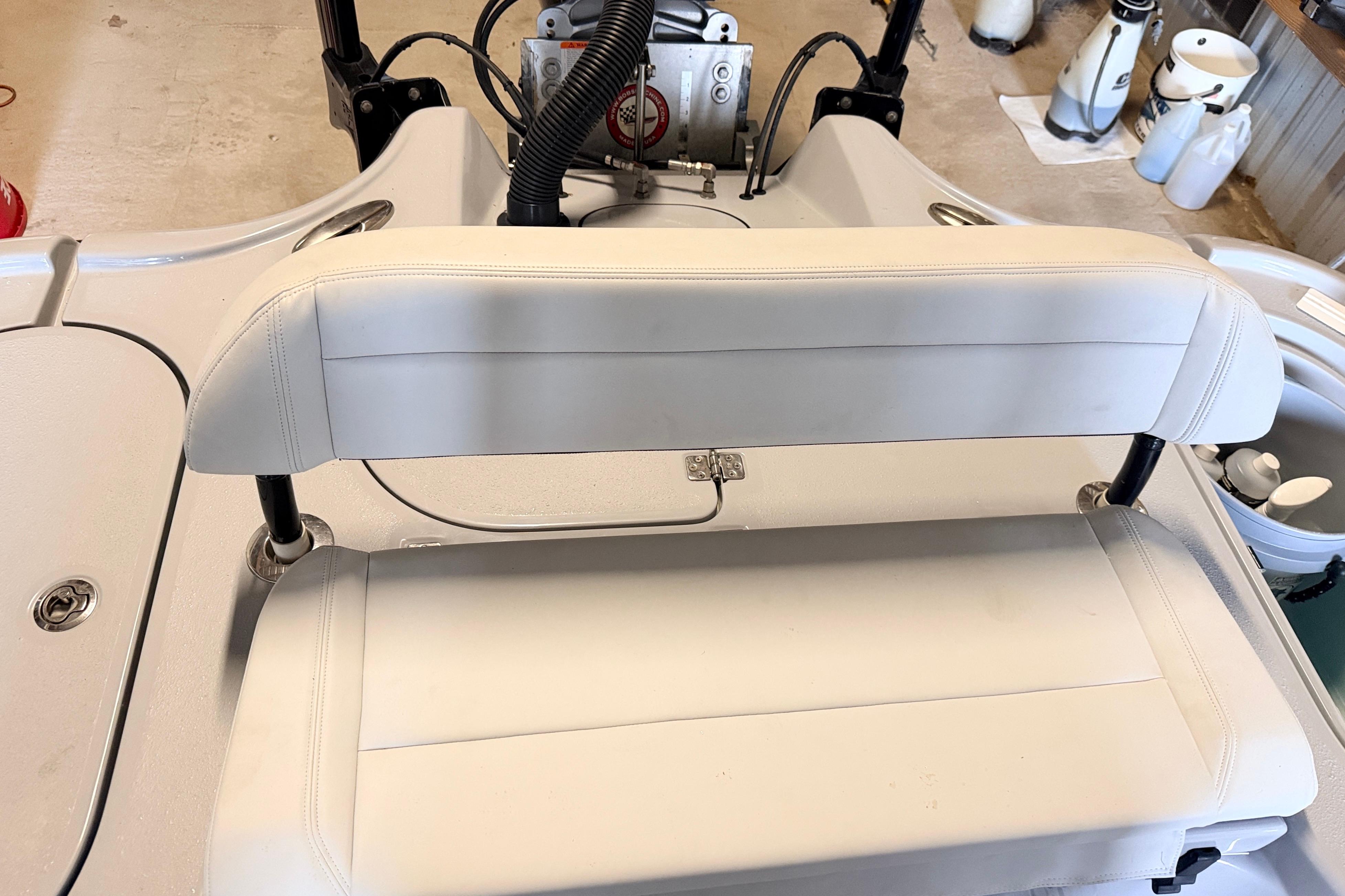2025 Yellowfin 24 Bay CE boat seat with white upholstery and storage compartment.