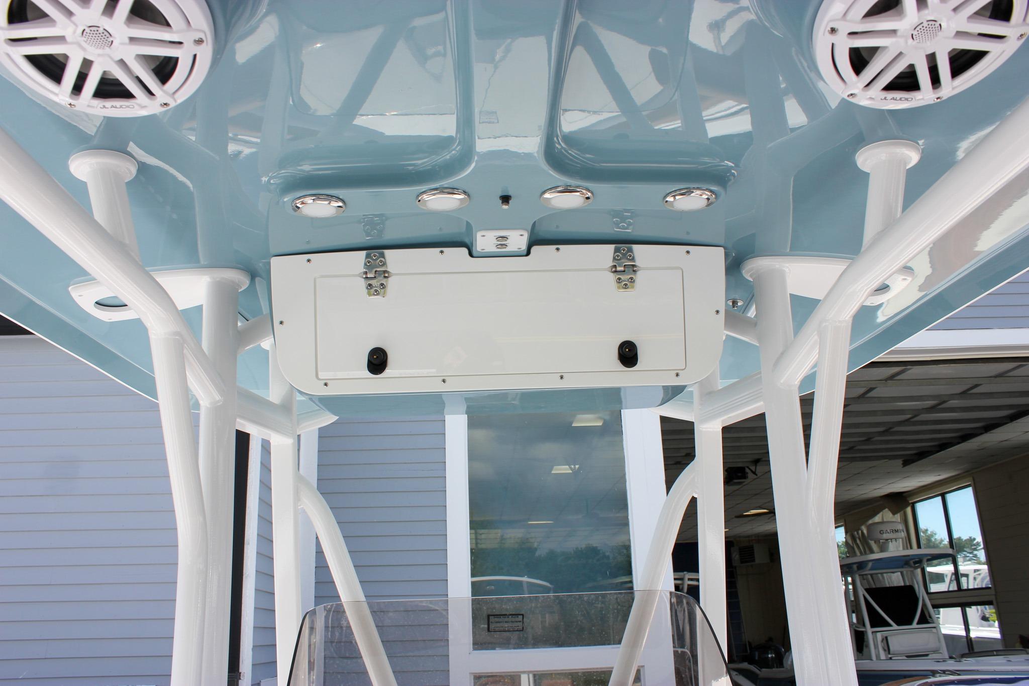 2027 Sea Hunt Ultra 234 boat T-top with speakers and storage compartment.