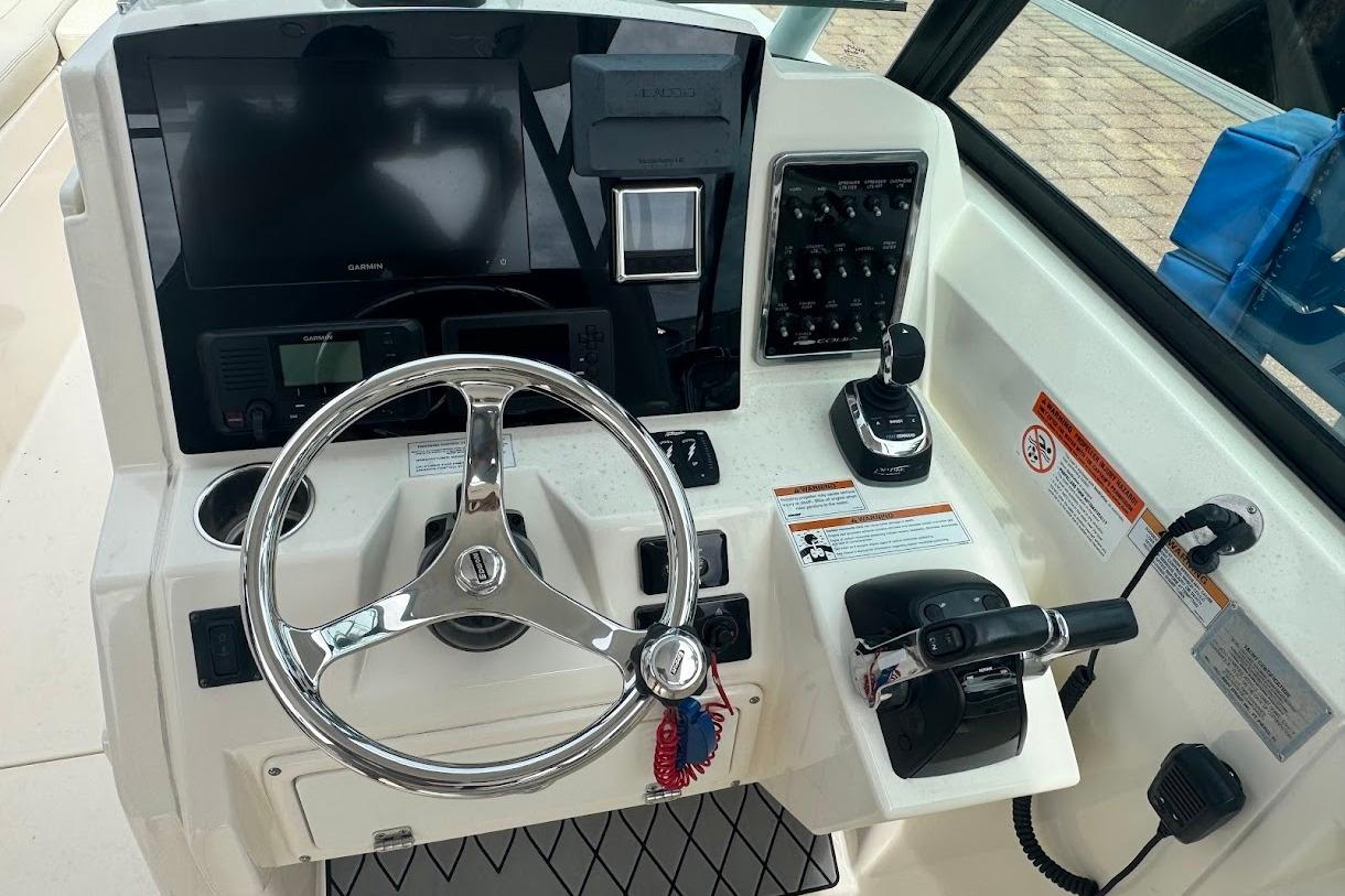 Cockpit of 2020 Cobia 280 Dual Console with steering wheel and control panel.