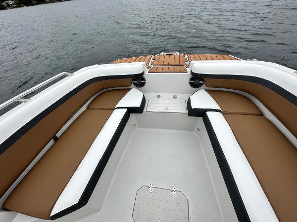 2025 Starcraft SVX 211 OB CC boat interior with tan and white seating on the water.